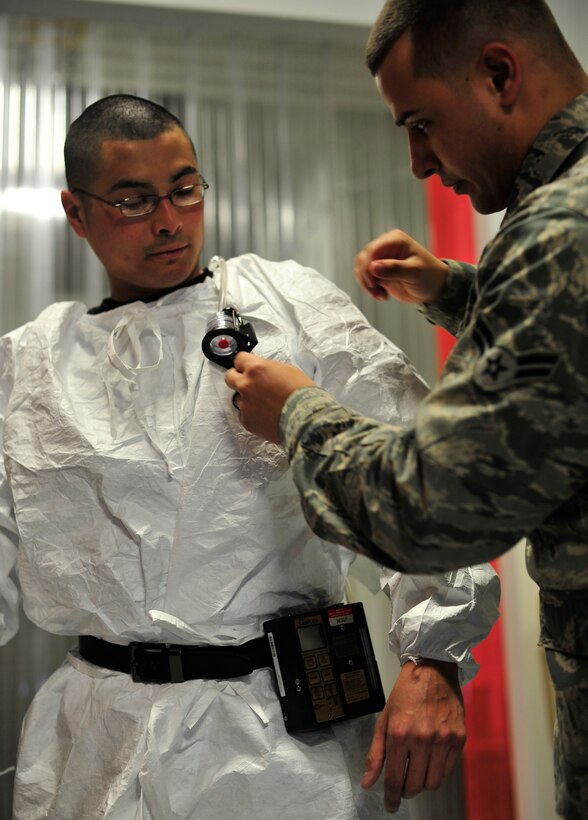 Airman 1st Class Peter Cambra, 779th Aerospace Medicine Squadron bioenvironmental engineer technician, places an air sampler on Tech. Sgt. John Mills-Hearne, a painter with the 459th Reserve Air Refueling Wing Jan. 23, 2013 on Joint Base Andrews, Md. Bioenvironmental Engineers are required to sample air on location to help monitor the amount of chemicals workers are exposed to. (U.S Air Force photo/ Airman 1st Class Erin O’Shea)