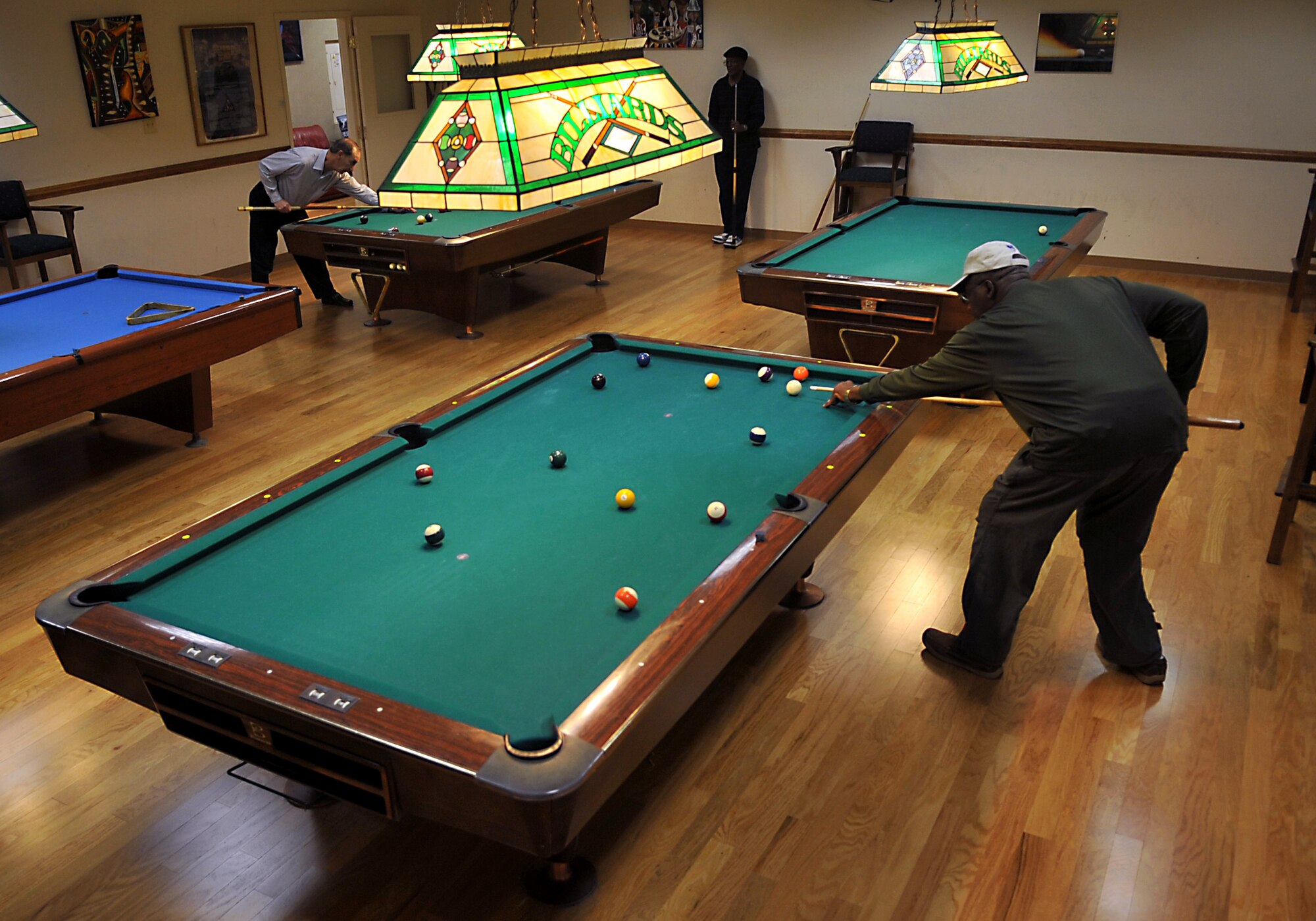 Patrons of the Langley Air Force Base, Va., Community Center play pool during lunch, Jan. 14, 2012. In the coming months, the Community Center will move into the renovated Youth Center to serve as the Community Commons, which will be a combination of the Community Center, Arts and Crafts, Information, Tickets and Tours, and parts of Outdoor Recreation. (U.S. Air Force photo by Staff Sgt. Katie Gar Ward/Released)