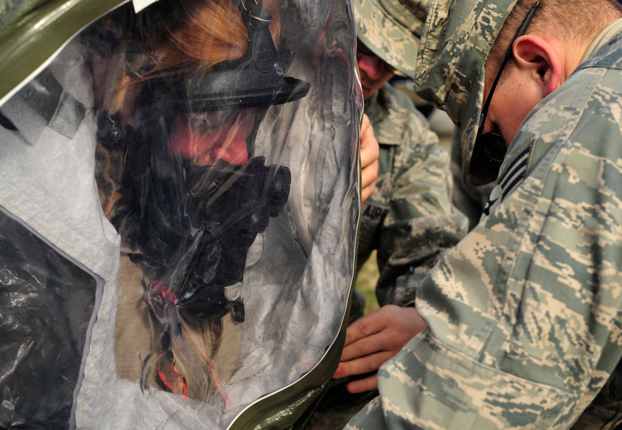 Staff Sgt. Christopher Kurban, 779th Aerospace Medicine Squadron bioenvironmental engineer, helps Airman 1st Class Bridgette Brzenzinski, 779th AMDS bioenvironmental engineering apprentice, put on her level A protection before a simulated exercise of clearing a vehicle of radiation Jan. 23, 2013 on Joint Base Andrews, Md. The level A protection consists of a self contained breathing apparatus, respirator and pack and a level A, fully encapsulating Tychem chemical protective suit.  (U.S. Air Force photo/ Airman 1st Class Erin O’Shea) 