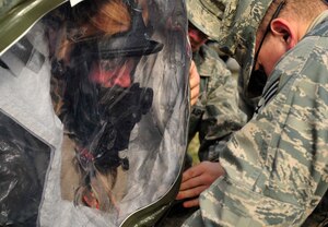 Staff Sgt. Christopher Kurban, 779th Aerospace Medicine Squadron bioenvironmental engineer, helps Airman 1st Class Bridgette Brzenzinski, 779th AMDS bioenvironmental engineering apprentice, put on her level A protection before a simulated exercise of clearing a vehicle of radiation Jan. 23, 2013 on Joint Base Andrews, Md. The level A protection consists of a self contained breathing apparatus, respirator and pack and a level A, fully encapsulating Tychem chemical protective suit.  (U.S. Air Force photo/ Airman 1st Class Erin O’Shea) 