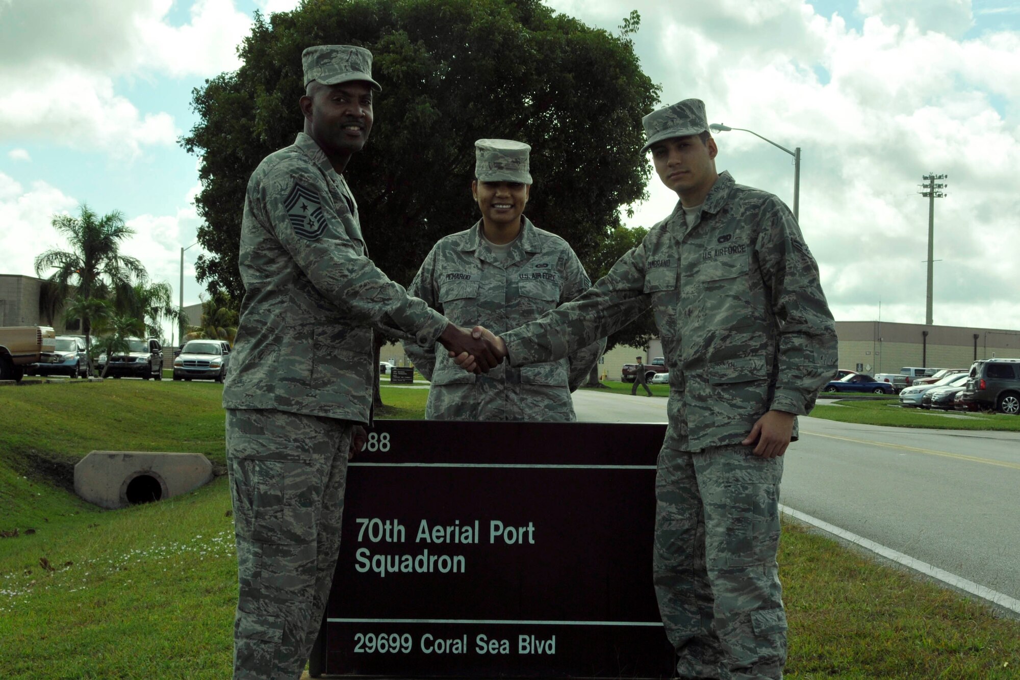 Chief Master Sgt. Cameron Kirksey (left), 482nd Fighter Wing command chief master sergeant, Senior Airman Cynthia Pichardo, Development and Training Flight program administer, welcom Airman 1st Class Diego Zambrano, 70th Aerial Port Squadron, back to Homestead Air Reserve Base, Fla., after his completion of basic training and technical school Dec. 7, 2012. Homestead ARB's Development and Training Flight is in full swing, training would-be Airmen on Air Force standards and practices before heading off to basic training to give them a leg up on their Air Force career. Recently, Homestead ARB’s Development and Training Flight welcomed back to the base its first Airman to have gone through the program and return from basic and technical training. (U.S. Air Force photo/Senior Airman Jaimi Upthegrove)