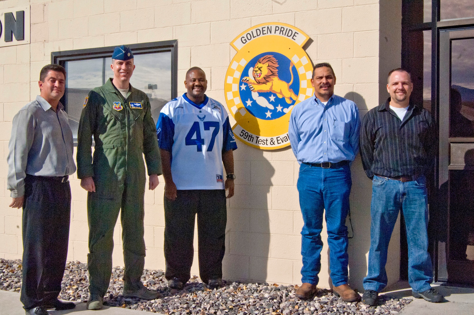 Members of the 59th Test and Evaluation Squadron pose for a photo outside the old data lab Jan. 25, 2013, at Nellis Air Force Base, Nev. The new data lab is scheduled to open Feb. 8 to accommodate the F-35 aircraft slated to arrive at Nellis this year. (U.S Air Force photo by Airman 1st Class Monet Villacorte)