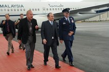Sultan Muhammad V of Kelantan, Malaysia, (center) is greeted by John D. Waihe'e III, former Governor of Hawaii, and Col. Johnny Roscoe, 15th Wing commander, Joint Base Pearl Harbor-Hickam, Hawaii 23 Jan.  Photo by David D. Underwood, Jr.