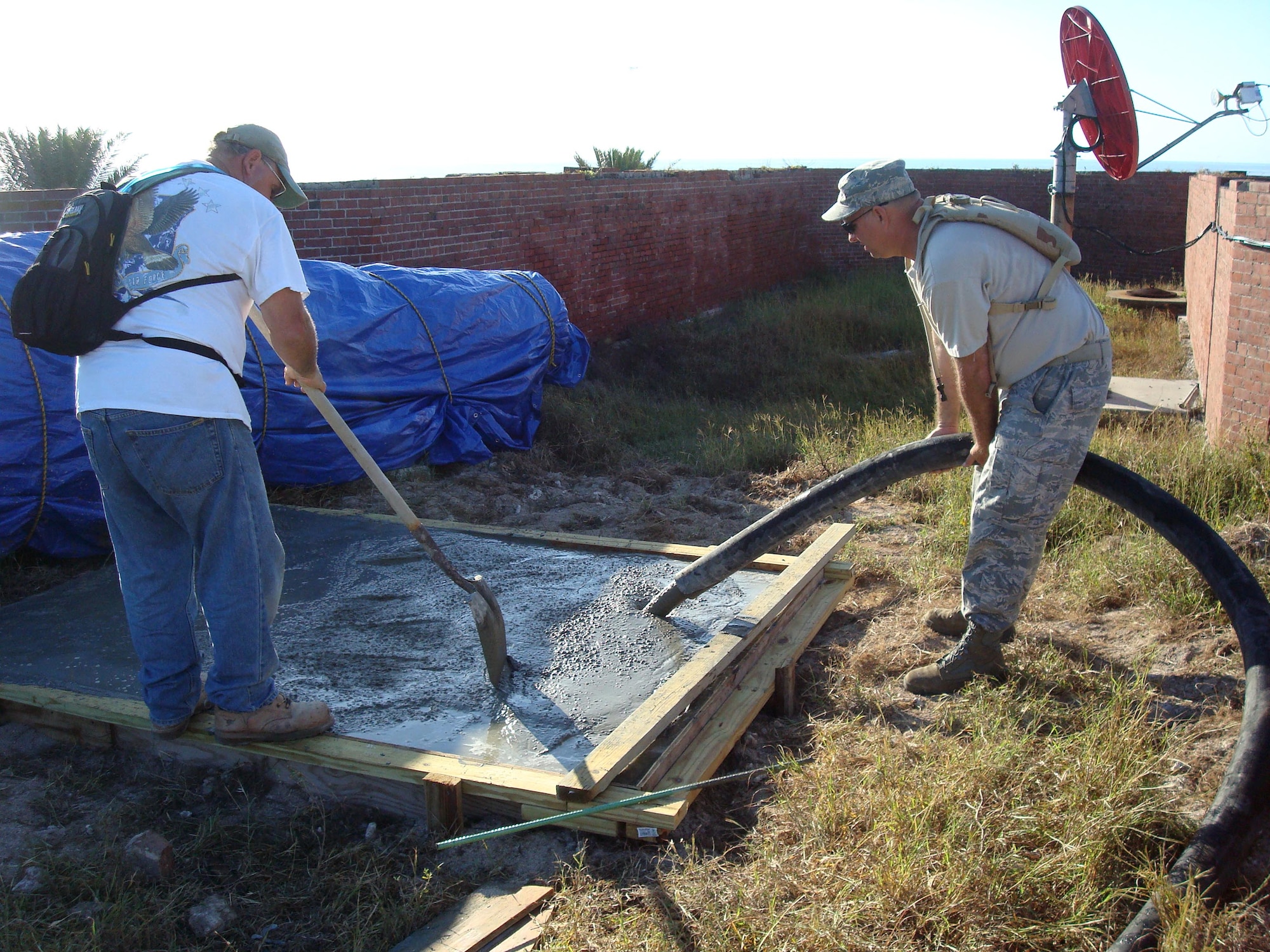 Retired Chief Master Sgt. Walter Horlacher, formerly of the 482nd Civil Engineer Squadron, and Chief Master Sgt. David Hanck, 482nd CES, pour the concrete for the base of one of the restored cannons at Fort Jefferson in the Dry Tortugas National Park Jan. 16. Air Force reservists both active and retired from Homestead Air Reserve Base’s 482nd Civil Engineer Squadron gathered at Fort Jefferson over several days in January to participate in a maintenance project for the National Park Service. 15 active reservists, six retired reservists, and one civilian contractor set up shop at Fort Jefferson as a training mission. The main project of the training was the construction of four reinforced concrete bases for large, 24-ton restored cannons to replicate the historical weapon's footprint. (U.S. Air Force photo/Ross Tweten)