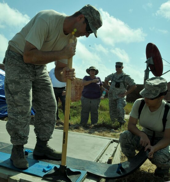 Master Sgt. Christopher Wilton (left) and Senior Airman Jessica Benitez, both of the 482nd Civil Engineer Squadron, stamp down the faux wood imprint on the concrete base for the restored cannons at Fort Jefferson in the Dry Tortugas National Park Jan. 17. Air Force reservists both active and retired from Homestead Air Reserve Base’s 482nd Civil Engineer Squadron gathered at Fort Jefferson over several days in January to participate in a maintenance project for the National Park Service. 15 active reservists, six retired reservists, and one civilian contractor set up shop at Fort Jefferson as a training mission. The main project of the training was the construction of four reinforced concrete bases for large, 24-ton restored cannons to replicate the historical weapon's footprint. (U.S. Air Force photo/Ross Tweten)