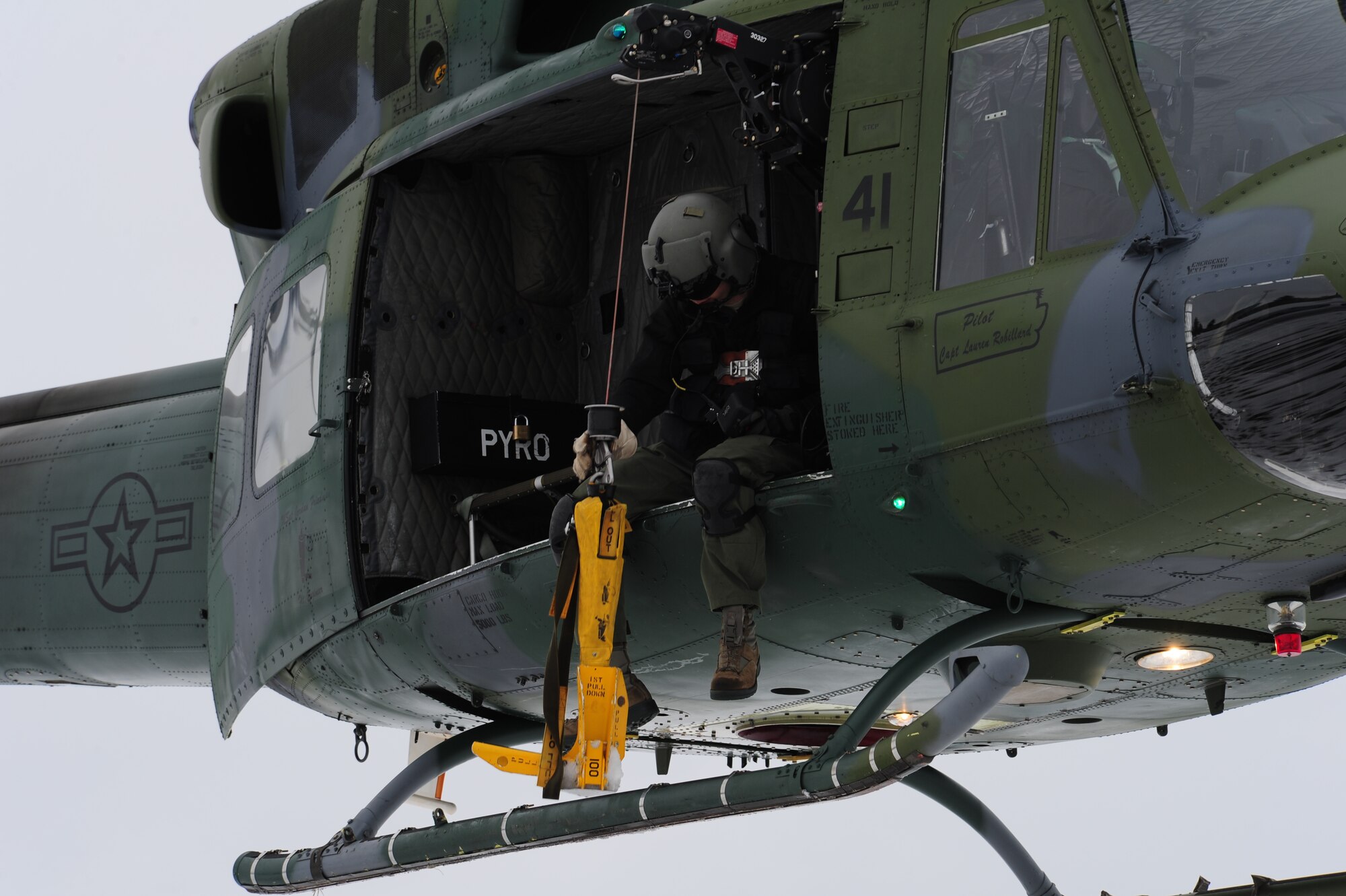 Staff Sgt. Nicholas Poe, a flight engineer with the 36th Rescue Flight, lowers a forest-penetrating device during a training exercise at the survival, evasion, resistance and escape school at Fairchild Air Force Base, Wash., Jan. 25, 2013. Nicholas has been with the rescue flight for two years. (U.S. Air Force photo by Airman 1st Class Janelle Patiño)