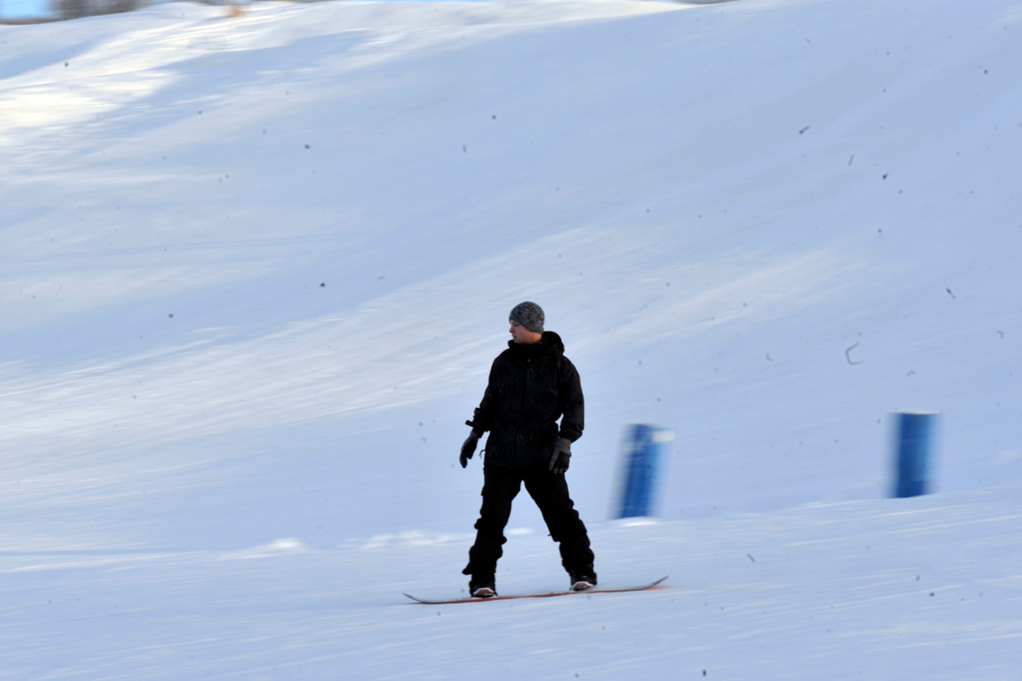 JOINT BASE ELMENDORF-RICHARDSON, Alaska -- Airman Dominick Mosacarelli, 673d Aerospace Medicine Squadron biotechnician, races down the Hillberg ski slope Jan. 21. The ski area is available to all JBER community members. (U.S. Air Force photo/Airman Ty-Rico Lea)