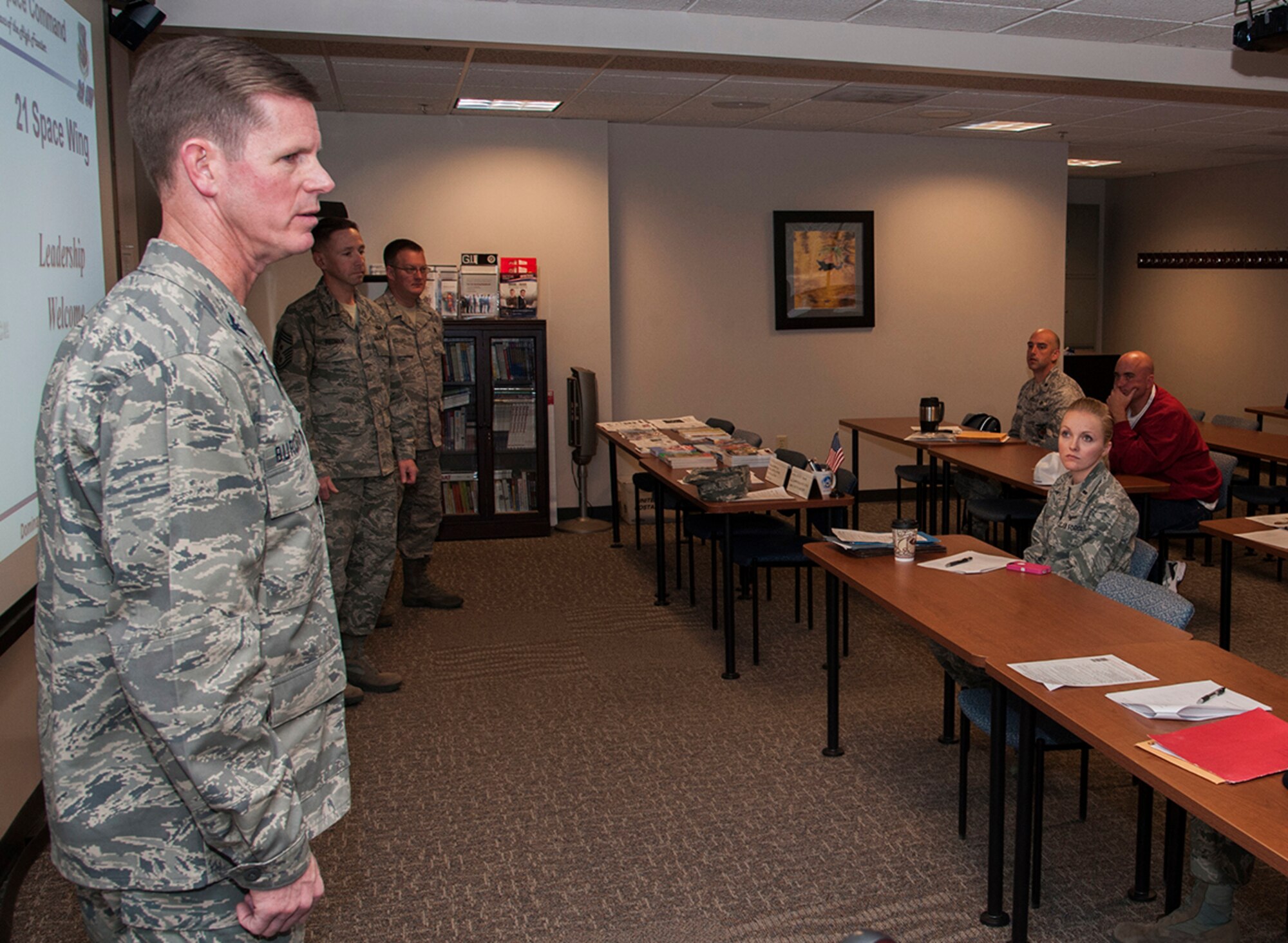 PETERSON AIR FORCE BASE, Colo. -- Col. Richard Burchfield, the new 21st Space Wing individual mobilization augmentee to the commander, welcomes Team Pete personnel back from their deployments Jan. 23 at the Airman and Family Readiness Center. The Peterson Welcome Home Briefing provides a central location for important information and includes briefings from the chapel and public health, financial readiness information, and more information intended to help personnel transition home from deployment. Other topics included construction updates and changes affecting the base. (U.S. Air Force photo/Craig Denton)
