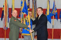 Community members and business leaders were appointed as 388th Fighter Wing
Honorary Commanders during a special change of command ceremony at Hill Air
Force Base, Utah, Jan. 25. Col. Scott Long (left), 388th FW commander, hands the
wing's guidon to his new honorary, Kaysville City Mayor Steve Hiatt, while
Chief Master Sgt. Mark Batzer, 388th command chief, looks on. (U.S. Air
Force photo/Released by Alex Lloyd)