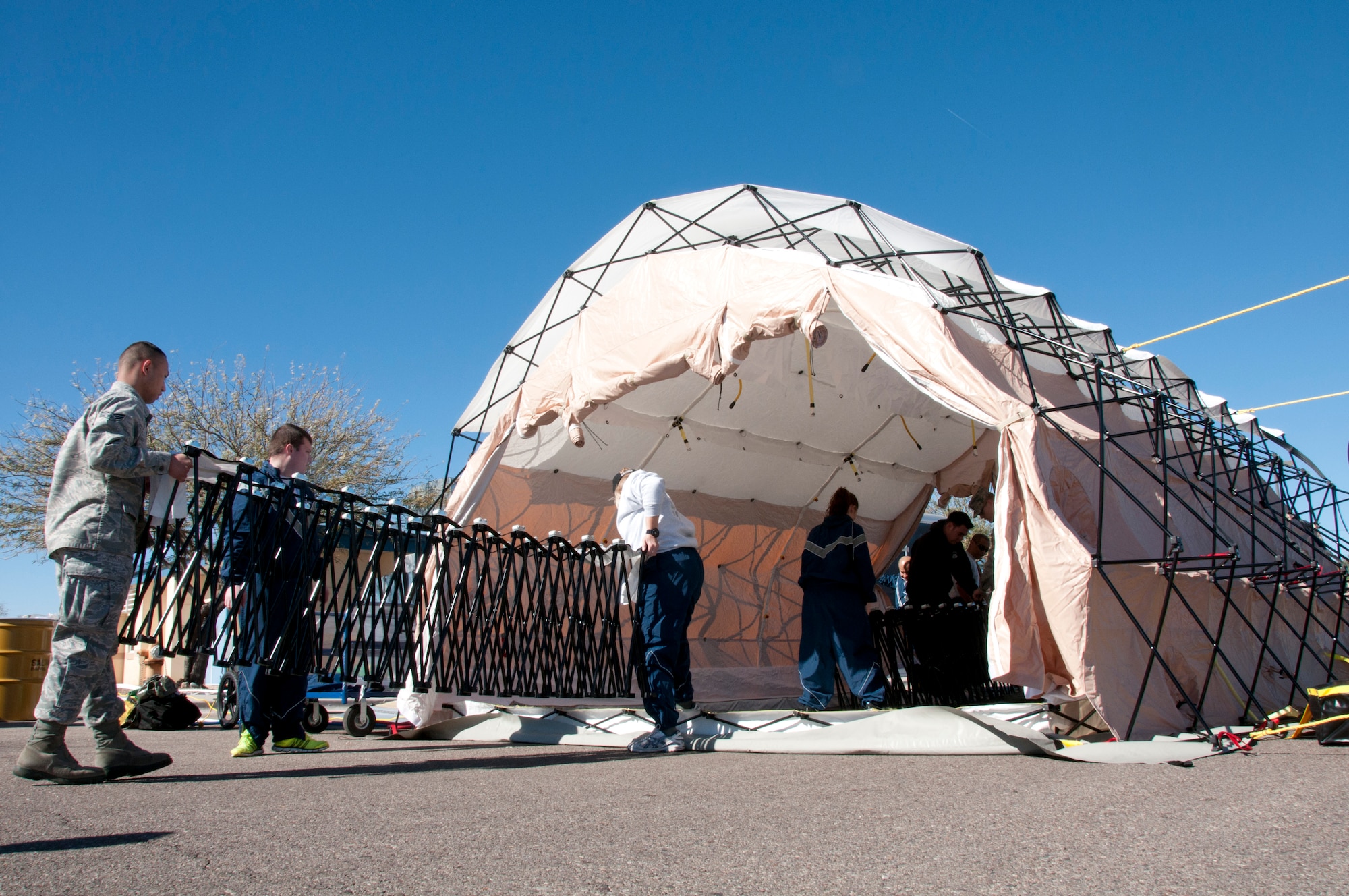 Members of the 162nd Fighter Wing, Tucson Ariz. construct a shelter used for
the decontamination of patients affected by chemical, biological,
radiological or nuclear (CBRN) contamination.  Medical Counter (MC)-CBRN
equipment packages such as this are being positioned at Air National Guard
installations throughout the United Sates to support domestic operations
involving the accidental or intentional terrorist use of CBRN materials.
(U.S. Air Force photo by Master Sgt. David Neve/Released)
