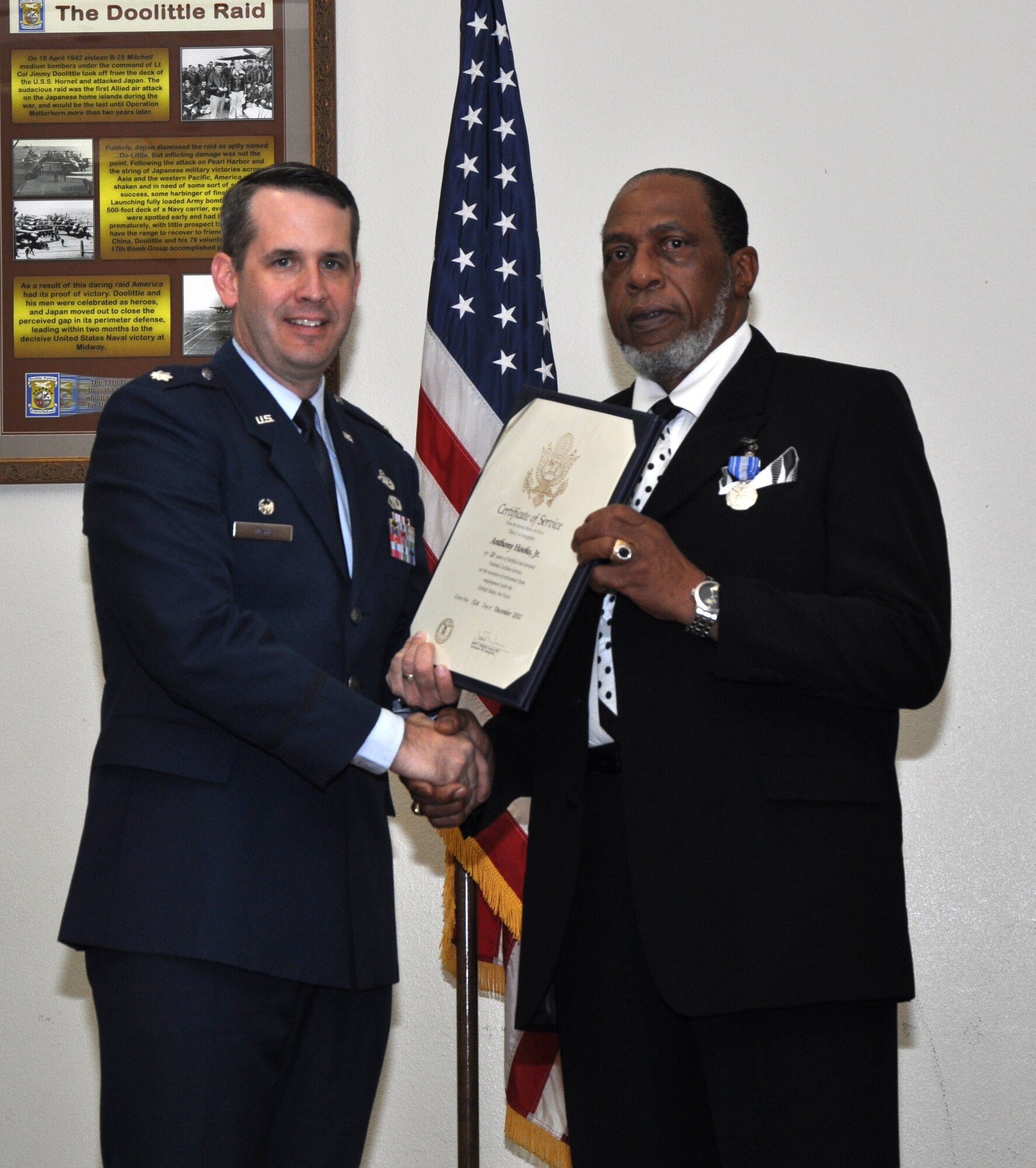 GOODFELLOW AIR FORCE BASE, Texas – Lt. Col. Ryan Dahl, 17th Force Support Squadron Commander, presents Anthony Hooks Jr., former Airman and Family Readiness Center flight chief, a certificate of service for Hook’s retirement ceremony at the Event Center, Jan. 25. Hook received this award for his civil service career, lasting over 20 years. (U.S. Air Force photo/ Airman 1st Class Joshua Edwards)