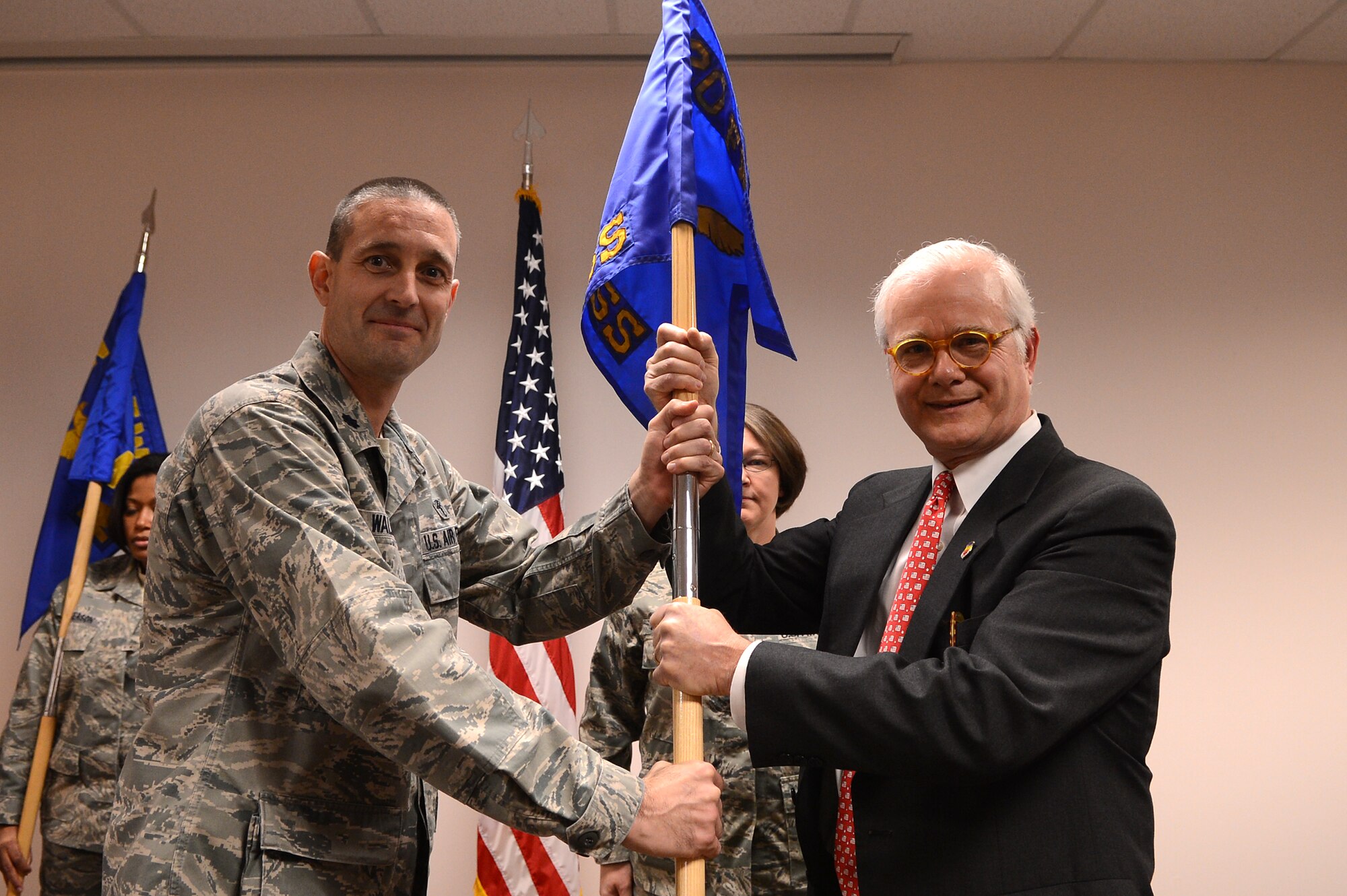U.S. Air Force Lt. Col. David Walmsley, 20th Medical Support Squadron commander, presents  Michael Mischner, Chronicle- Independent news editor with a guide-on as he assumes the title of honorary commander for the 20th MDOS at Shaw Air Force Base, S.C., Jan. 22, 2013. The purpose of the Air Force honorary commander program is to increase public awareness and understanding of the armed forces and its mission, policies and programs of the AF, and to build relationships with members of the local community and encourage them to share the AF story.  (U.S. Air Force photo by Airman 1st Class Nicole Sikorski/Released)