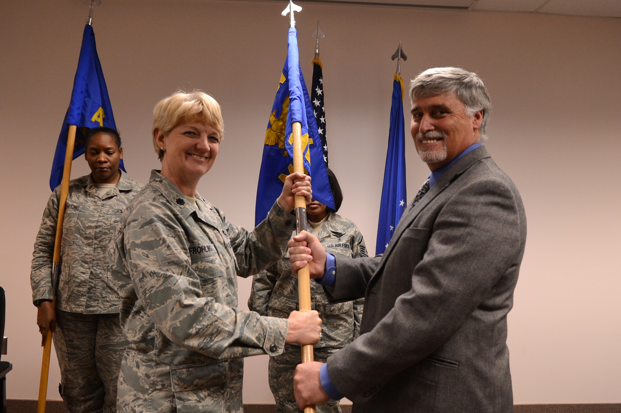 U.S. Air Force Lt. Col. Colleen Frohling, 20th Medical Operations Squadron commander, presents Glen Peagler, Sumter behavioral health services executive director with a guide-on as he assumes the title of honorary commander for the 20th MDSS at Shaw Air Force Base, S.C., Jan. 22, 2013.  The purpose of the Air Force honorary commander program is to increase public awareness and understanding of the armed forces and its mission, policies and programs of the AF, and to build relationships with members of the local community and encourage them to share the AF story. (U.S. Air Force photo by Airman 1st Class Nicole Sikorski/Released)