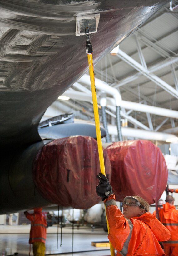 Airman 1st Class Kesha Wells, 28th Aircraft Maintenance Squadron weapons load crew member, scrubs a B-1 during a wash at Ellsworth Air Force Base, S.D., Jan 16, 2013. The B-1 must be washed before its initial home station check, which ensures the aircraft is fully mission capable.(U.S. Air Force photo by Airman 1st Class Alystria Maurer/Released)