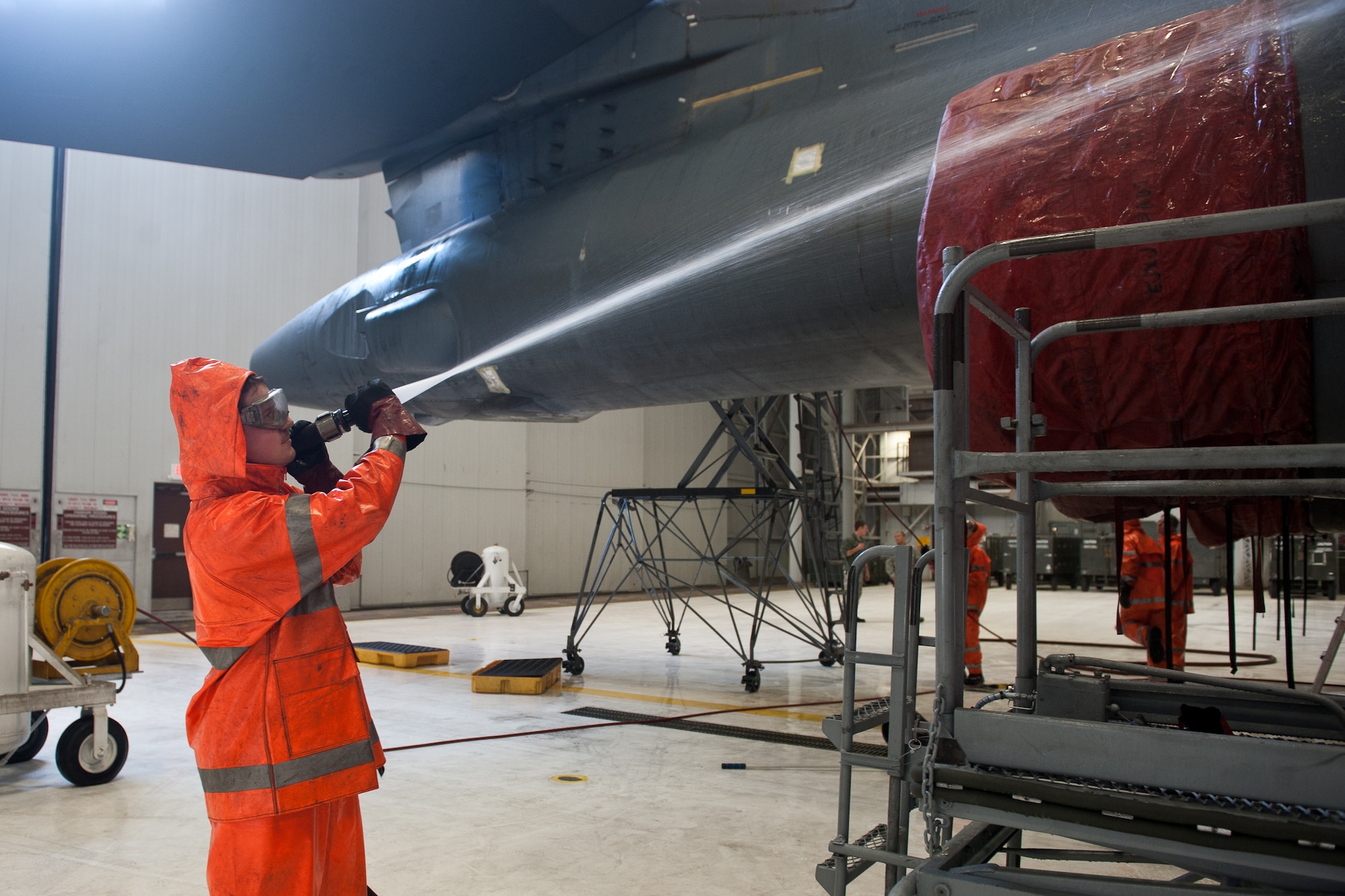 Airman 1st Class Jordan Gomez, 28th Aircraft Maintenance Squadron crew chief, sprays down a B-1 bomber, Jan. 16, 2013 at Ellsworth Air Force Base, S.D., as part of the aircraft’s maintenance schedule. Aircraft are washed every 120 days, or upon return from deployment, to ensure dirt doesn’t build and make working on the aircraft easier. (U.S. Air Force photo by Airman 1st Class Alystria Maurer/Released)