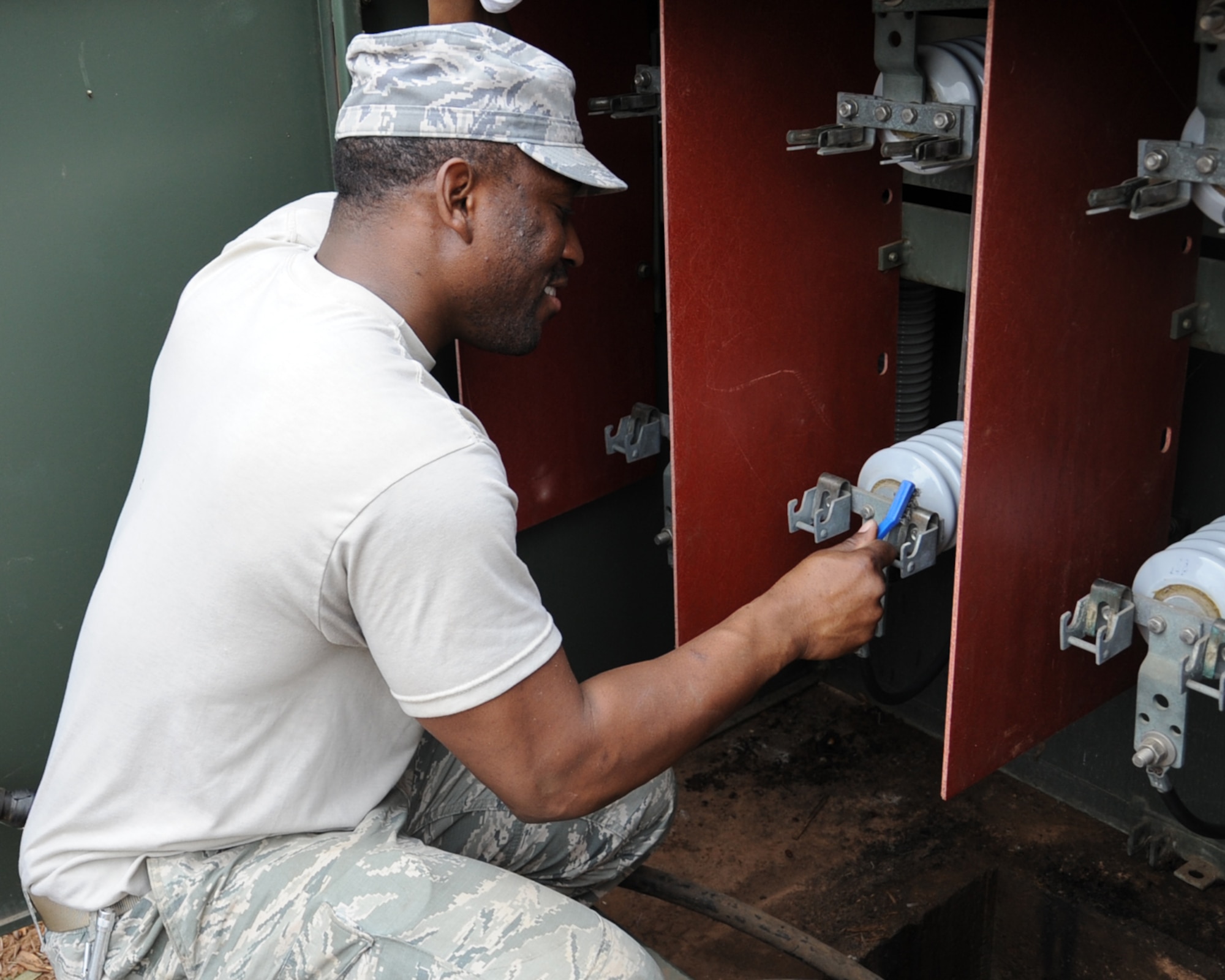 Tech. Sgt. Benjamin White, 2nd Civil Engineer Squadron electrical system craftsman, cleans high voltage insulators on a transformer on Barksdale Air Force Base, La., Jan. 29. The insulators must be cleaned in order to prevent high voltage electrical arcs from collecting and destroying the transformer. (U.S. Air Force photo/Senior Airman Sean Martin)