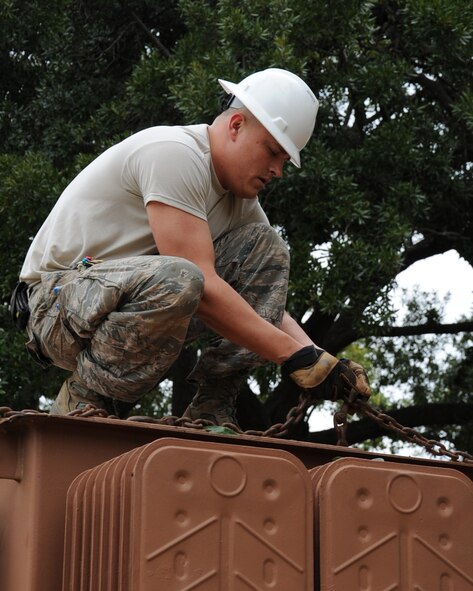 Staff Sgt. Shane Derrick, 2nd Civil Engineer Squadron electrical system craftsman, secures a transformer to a crane on Barksdale Air Force Base, La., Jan. 29. The transformer was damaged during a storm and needed to be repaired. (U.S. Air Force photo/Senior Airman Sean Martin)