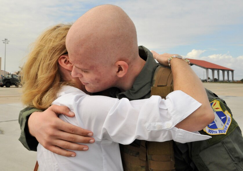 Air Force Junior ROTC cadet Coleton Wells hugs his mother Cara Wells prior to his flight on a HH-60G Pave Hawk rescue helicopter.  Wells spent the day touring the 920th RQW and learning the ins and outs of rescue. (U.S. Air Force photo/Tech. Sgt. Peter Dean)

