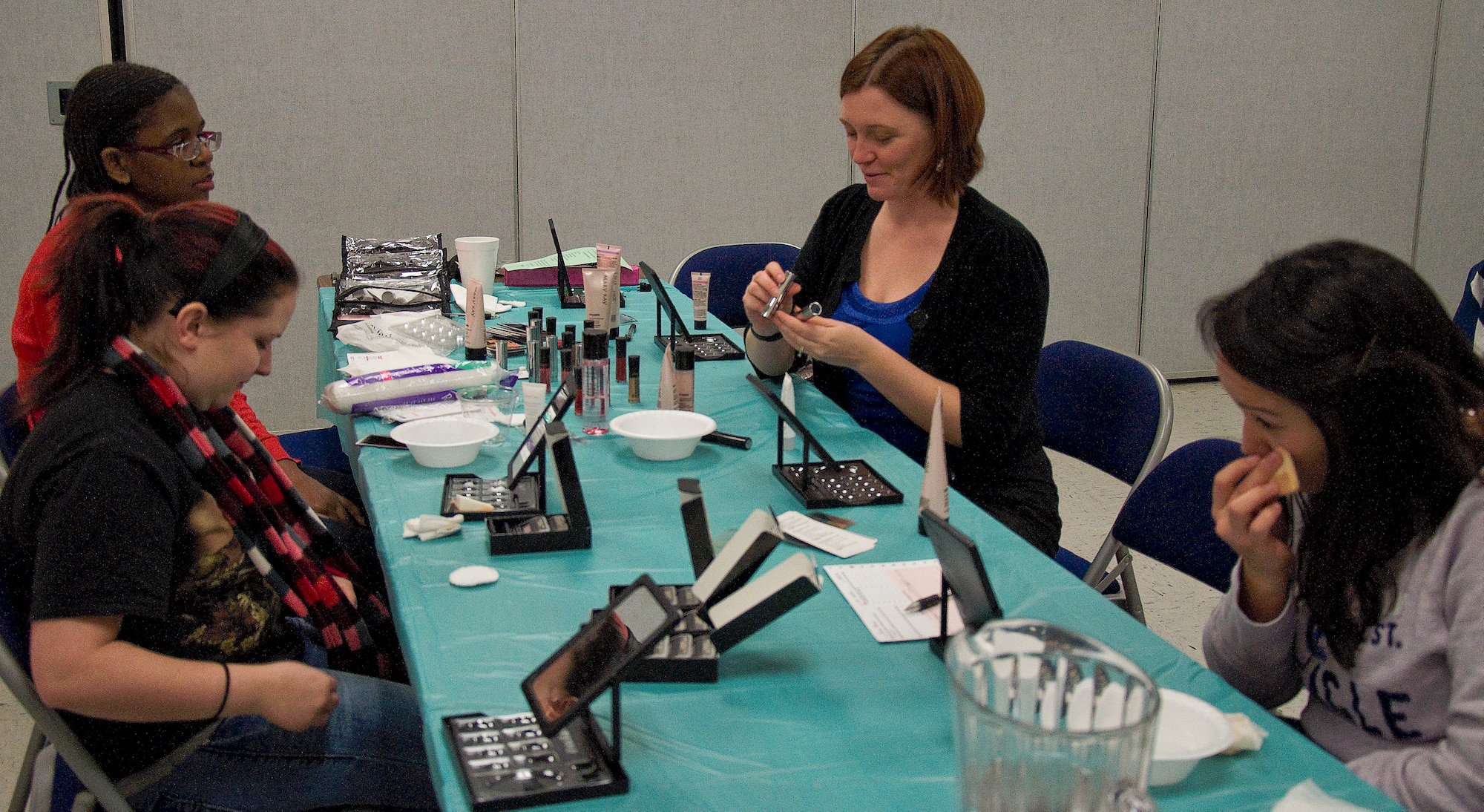 Spouses of deployed Airmen apply makeup during a spa day at Chapel 2 Jan. 25, 2013, at Dover Air Force Base, Del. It was an opportunity for Team Dover to offer the spouses a couple hours of relaxation, pampering, food and fellowship. (U.S. Air Force photo/Airman 1st Class Ashlin Federick)