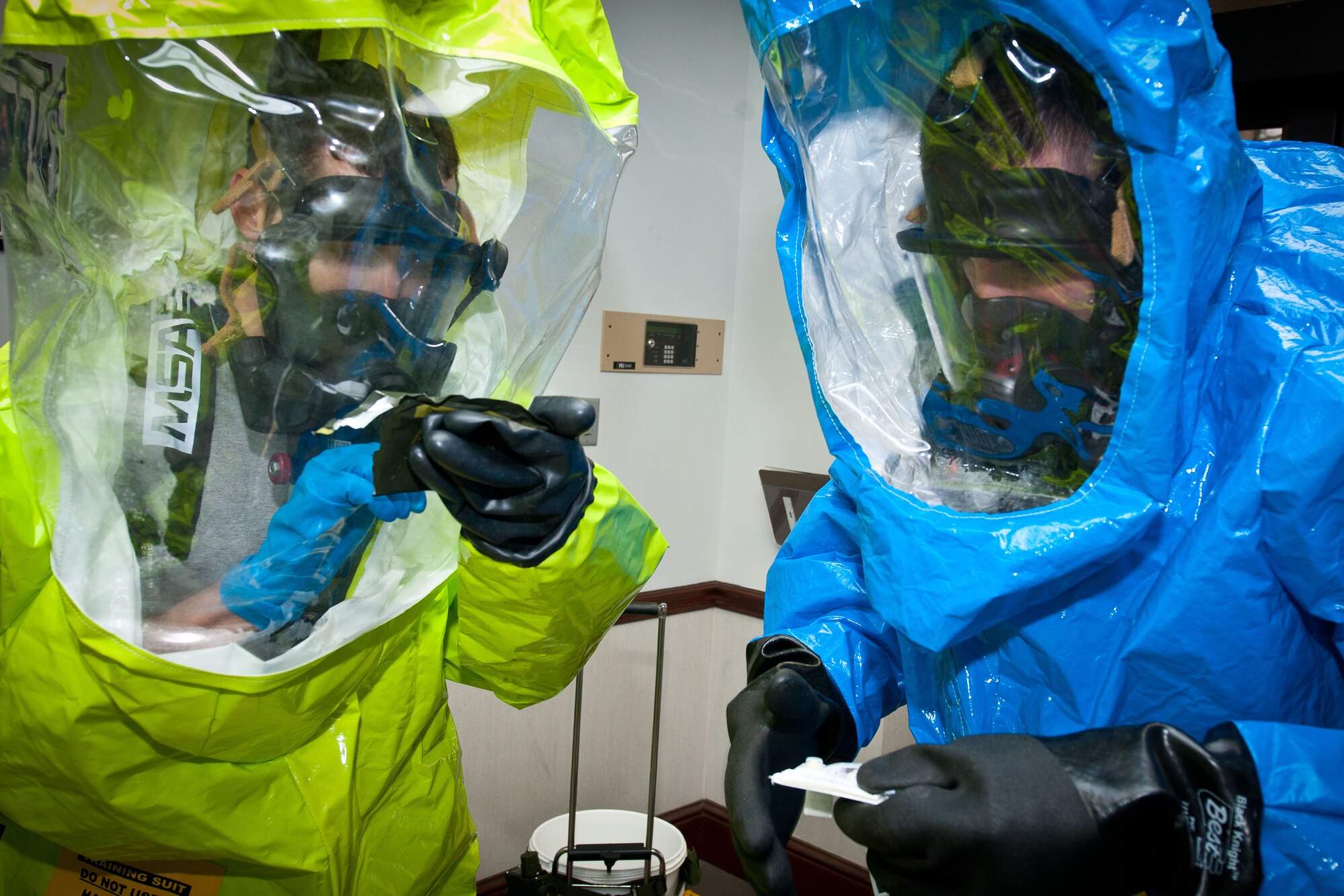 Members of the hazardous materials entry team, wearing chemical protective suits, enter building 836 to sample for nerve agents on Maxwell Air Force Base during a nerve-agent exercise Jan 17. (U.S. Air Force photograph by Donna L. Burnett)