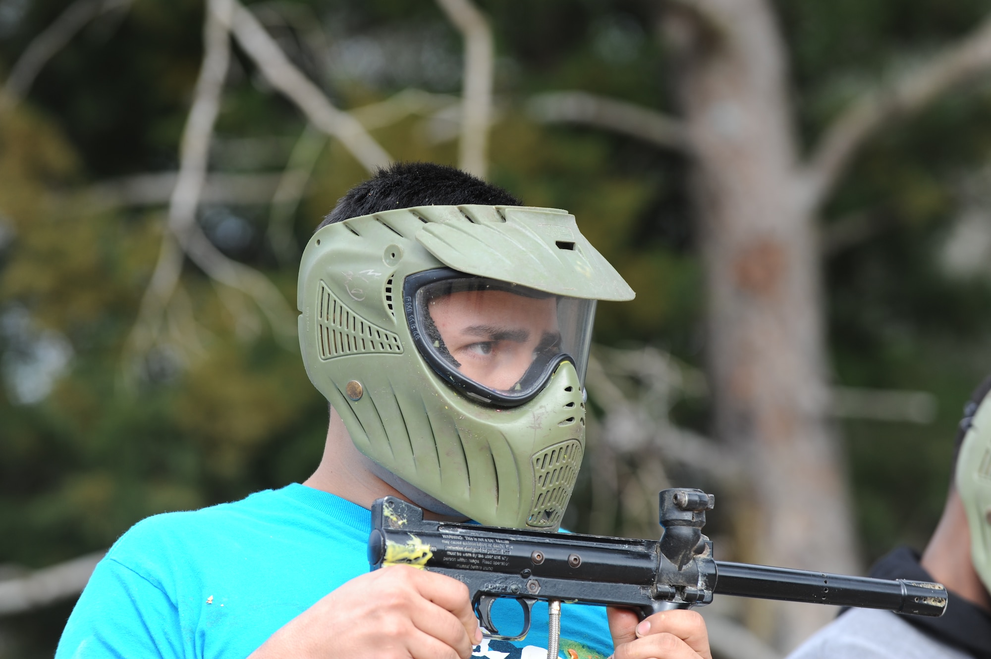 A Hurlburt Airman focuses before taking aim at his opponents during a paintball match at the base paintball field at Hurlburt Field, Fla., Jan. 25, 2013. Under "Civil War" rules of this match, each team member were given one shot per round to hit a player of the opposing team. (U.S. Air Force photo / Senior Airman Joe McFadden)