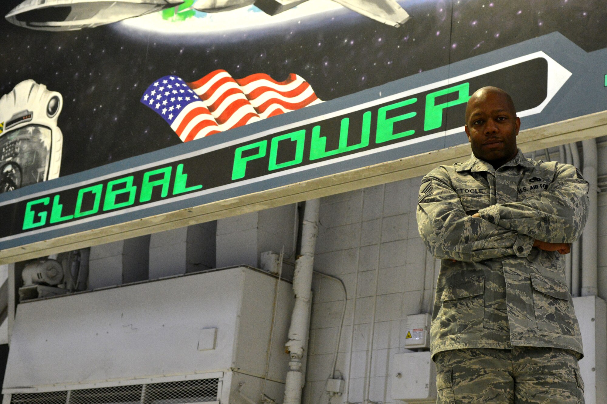 U.S. Air Force Master Sgt. Maurice Toole, 20th Aircraft Maintenance Squadron, squadron lead production superintendent, poses for a picture in the maintenance hangar as the Shaw Spotlight, Shaw Air Force Base, S.C. Jan.25, 2013. Toole is the spotlight for the week of Jan. 28 to Feb.1. (U.S. Air Force photo by Airman 1st Class Ashley L. Gardner/Released)