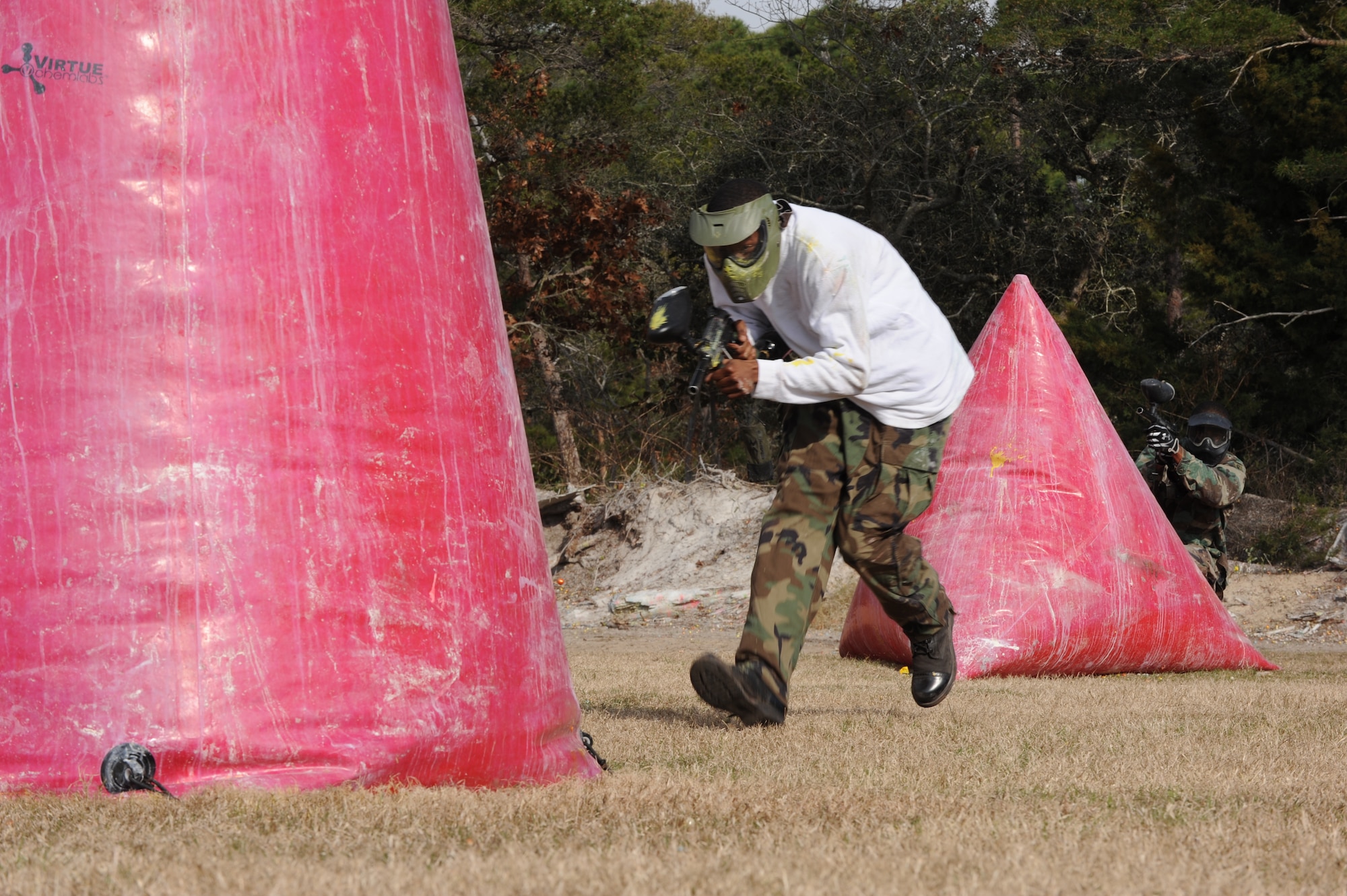 A Hurlburt Airman runs for cover as his teammate returns paintball fire during a paintball match at the base paintball field at Hurlburt Field, Fla., Jan. 25, 2013. A single hit from a paintball weapon disqualified a player from continuing the game. (U.S. Air Force photo / Senior Airman Joe McFadden)