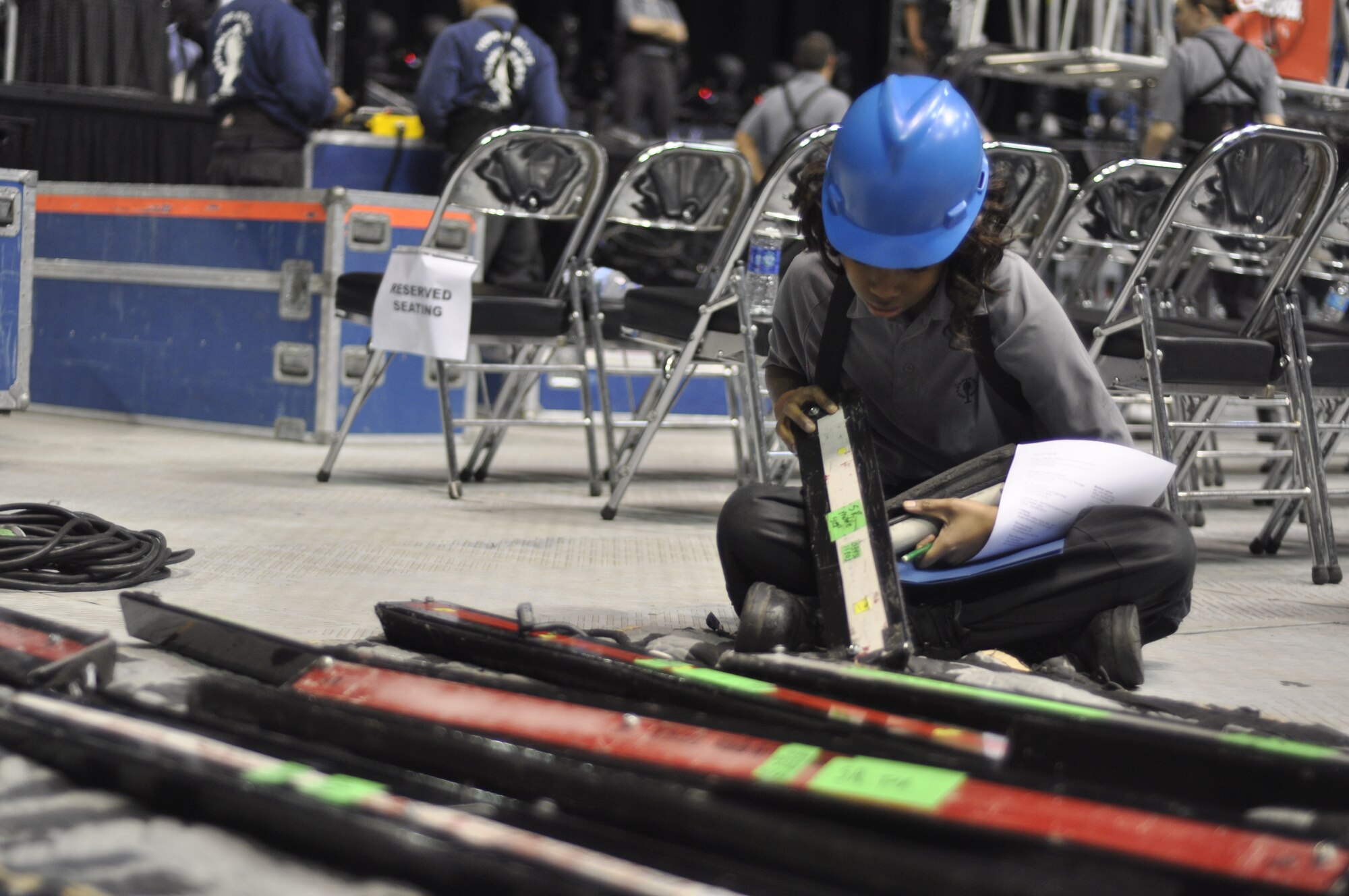 Airman 1st Class Jessica Pitts, Tops in Blue trumpet player, checks serial numbers on lights in preparation for the team’s show for Keesler Air Force Base Airmen and community members Jan. 27, 2013 at the Mississippi Coast Coliseum. In addition to performing, each member of the group is responsible for setting up and tearing down their equipment for each show. This year’s tour takes the group to more than 20 countries with nearly 130 performances. For more information on the team or audition requirements, visit www.topsinblue.com.  (U.S. Air Force photo by 1st Lt. Victoria Porto) 