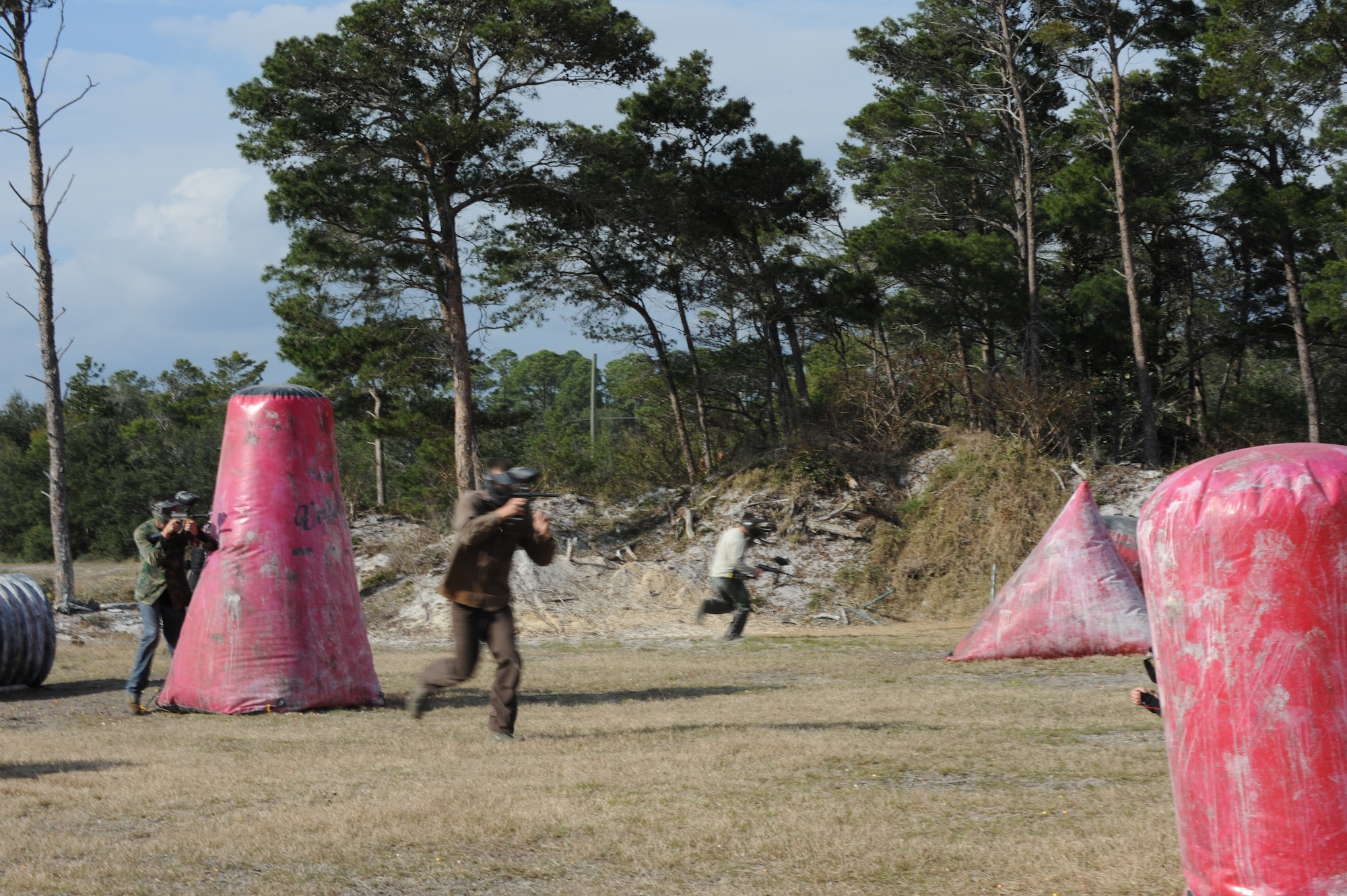 A team of Hurlburt Airmen seize territory against another team during a paintball match at the base paintball field at Hurlburt Field, Fla., Jan. 25, 2013. The free paintball match was provided by the base community center. (U.S. Air Force photo / Senior Airman Joe McFadden)