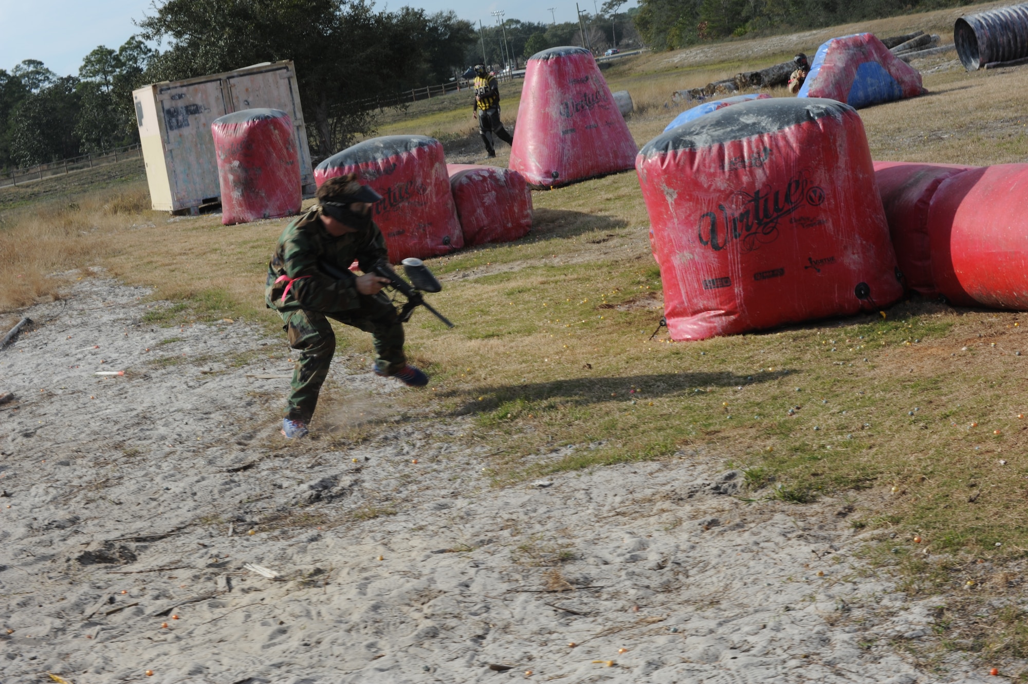A Hurlburt Airman heads for cover during a rapid-action paintball match at the base paintball field at Hurlburt Field, Fla., Jan. 25, 2013. The rapid-action game, which pitted two teams against each other in a half-acre size field, were over in as little as five minutes. (U.S. Air Force photo / Senior Airman Joe McFadden)