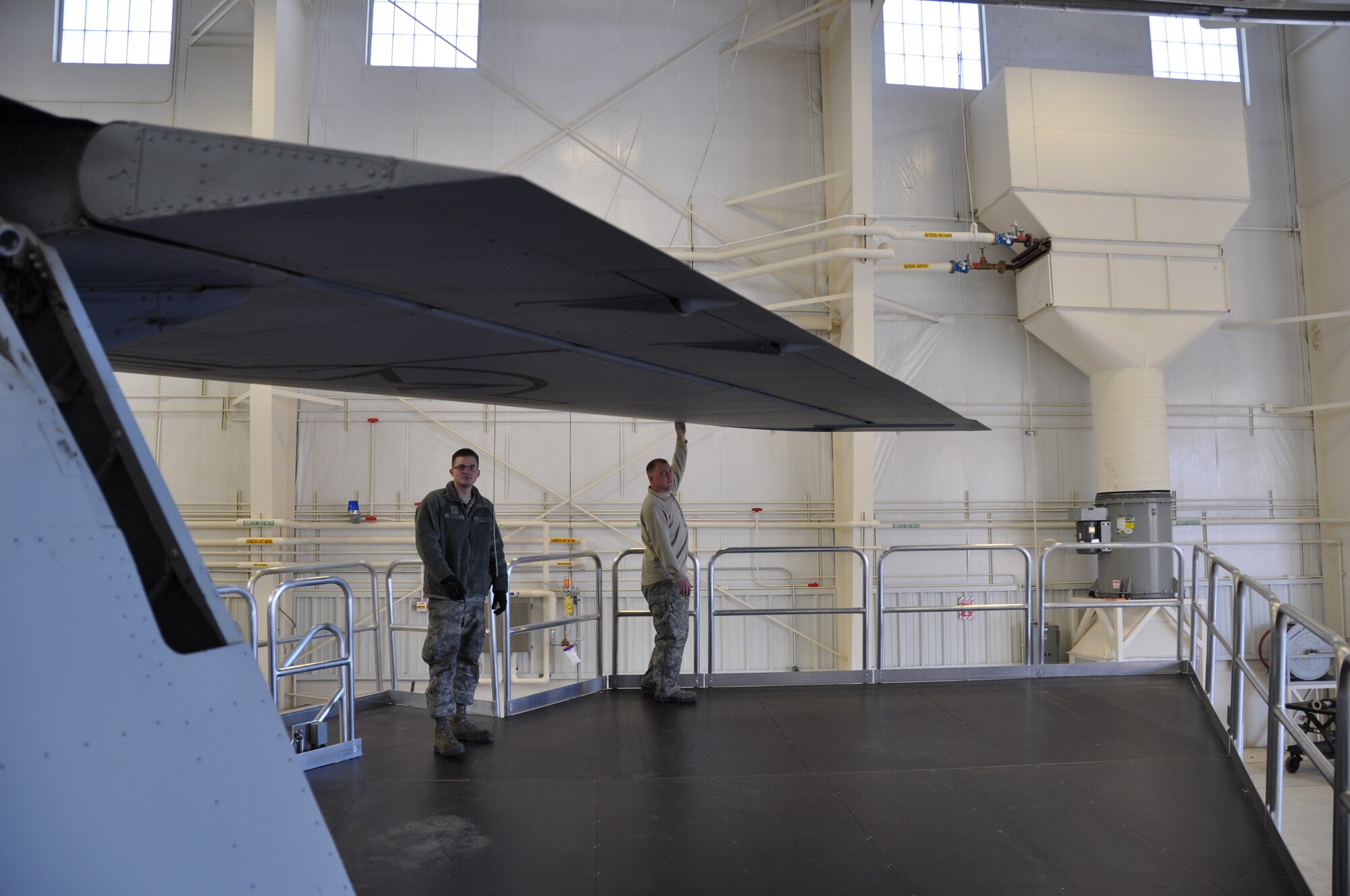 Master Sgt. Jason Lawson, right, and Airman 1st Class Mykal Short, left, both of the 507th maintenance squadron test the height of the new KC-135 maintenance platforms as they work their way around the wing of a Stratotanker.  The new platforms are part of a package of platforms and stands that is expected to increase safety and decrease inspection times.  (Photo by Senior Airman Mark Hybers) 
