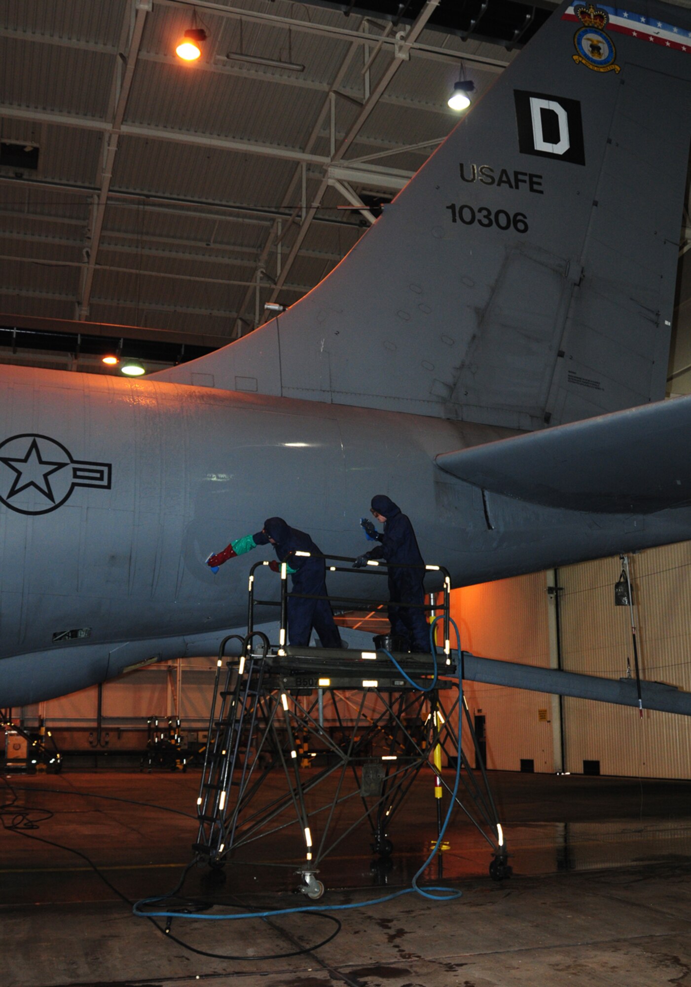 From left, Senior Airman Daniel Smith, from Mashpee, Mass., and Staff Sgt. Gary Vidrine, from Terrehaute, Indiana, 100th Aircraft Maintenance Squadron crew chiefs, wash the tail of a KC-135R Stratotanker Jan. 25, 2013, in the washrack at RAF Mildenhall, England. The six-hour process ensures the aircraft is thoroughly cleaned from nose to tail and wing tip to wing tip. (U.S. Air Force photo by Karen Abeyasekere/Released)