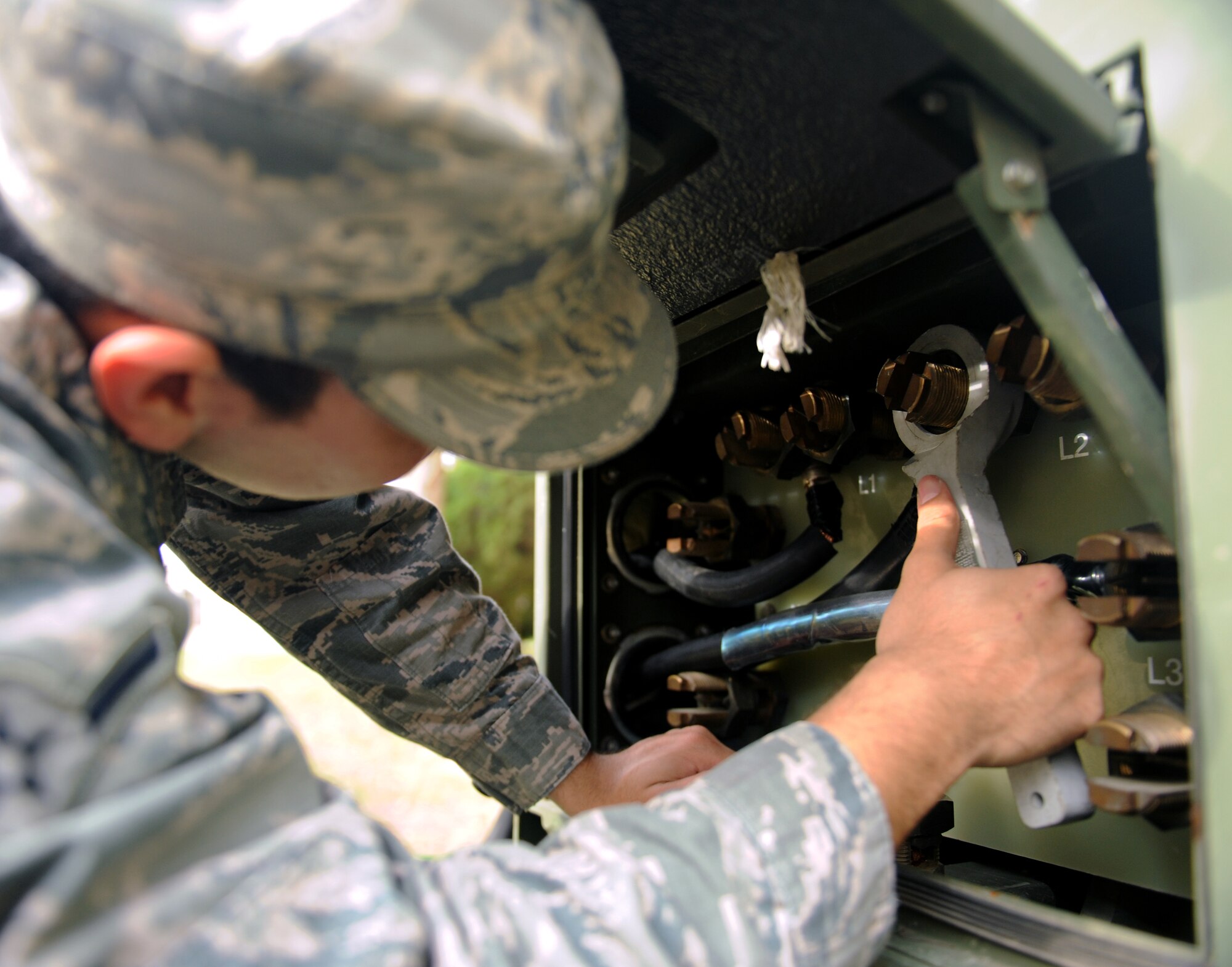 Airman Francisco Cerda, 2nd Civil Engineer Squadron electrical power production, tightens a cable into a MEP-809 generator on Barksdale Air Force Base, La., Jan. 28. The generator is used for emergencies during a power outage. (U.S. Air Force photo/Airman 1st Class Benjamin Gonsier)

