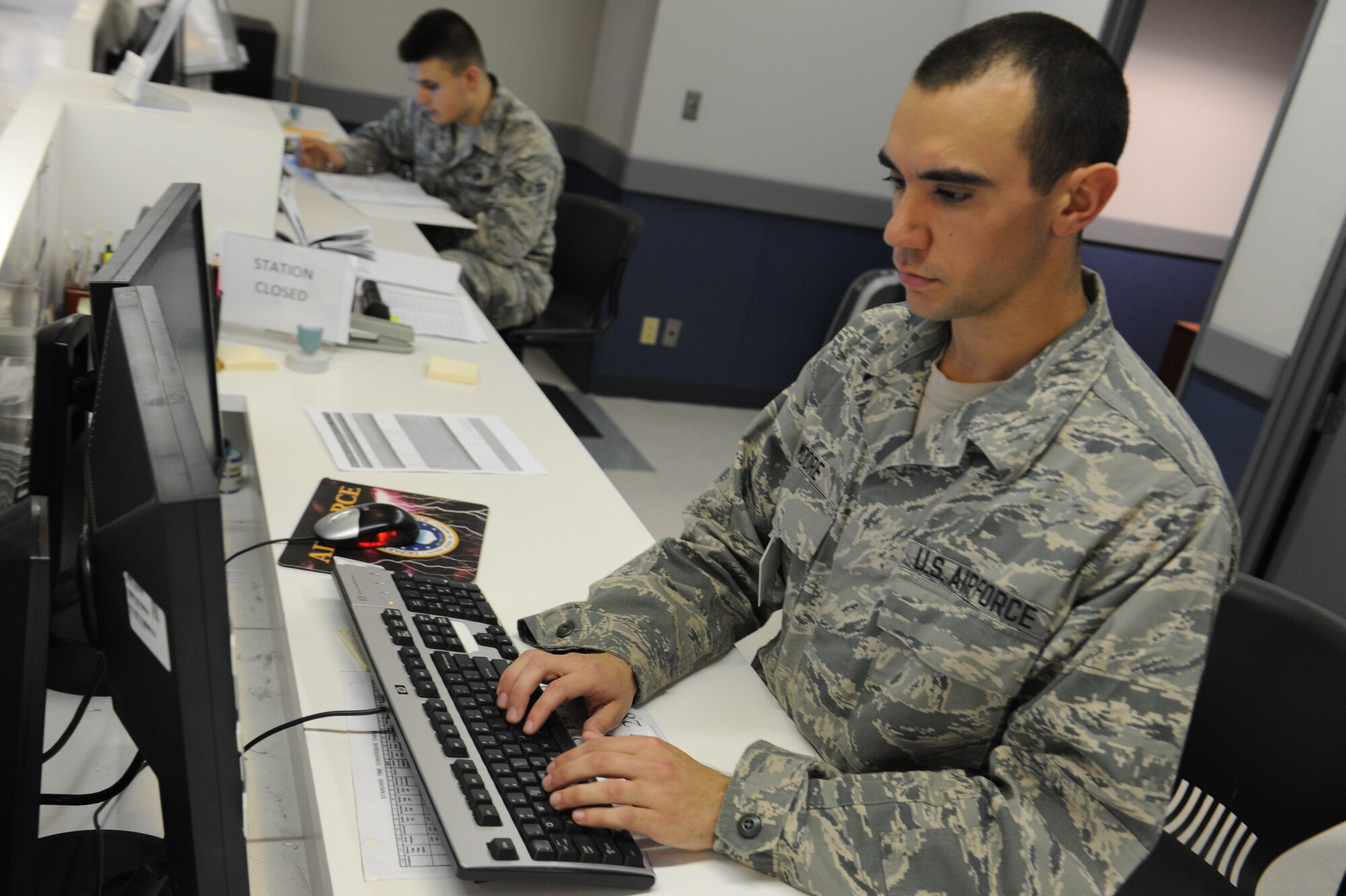 U.S. Air Force Airman Basic Josh Moore, 733rd Air Mobility Squadron air transportation passenger service agent, looks up information for the Space Availability program on Kadena Air Base, Japan, Jan. 29, 2013. Service members and their families can receive information about the Space Availability program at the passenger terminal or on the Air Mobility Command Space A website on the Kadena home page. (U.S. Air Force photo/Airman 1st Class Malia Jenkins)