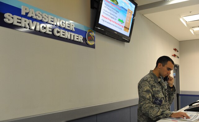 U.S. Air Force Airman Basic Josh Moore, 733rd Air Mobility Squadron air transportation passenger service agent, updates flight rosters on Kadena Air Base, Japan, Jan. 29, 2013. To get a flight in the Space Availability program, service members and their families would start their process at the passenger terminal. (U.S. Air Force photo/Airman 1st Class Malia Jenkins)