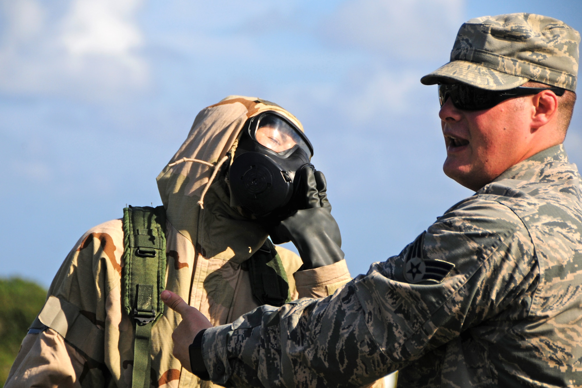 Senior Airman Eric Gibson, 36th Civil Engineer Squadron readiness and emergency management flight instructor, inspects an Airman’s chemical suit while explaining the importance of the proper wear of chemical gear at Andersen Air Force Base, Guam, Jan. 28, 2013.  The 36th CES readiness and emergency management flight’s primary mission is to manage programs that save lives, minimize the loss or degradation of resources and to sustain and restore operational capability through hazardous physical and environmental threats. (U.S. Air Force photo/Airman 1st Class Marianique Santos/Released)