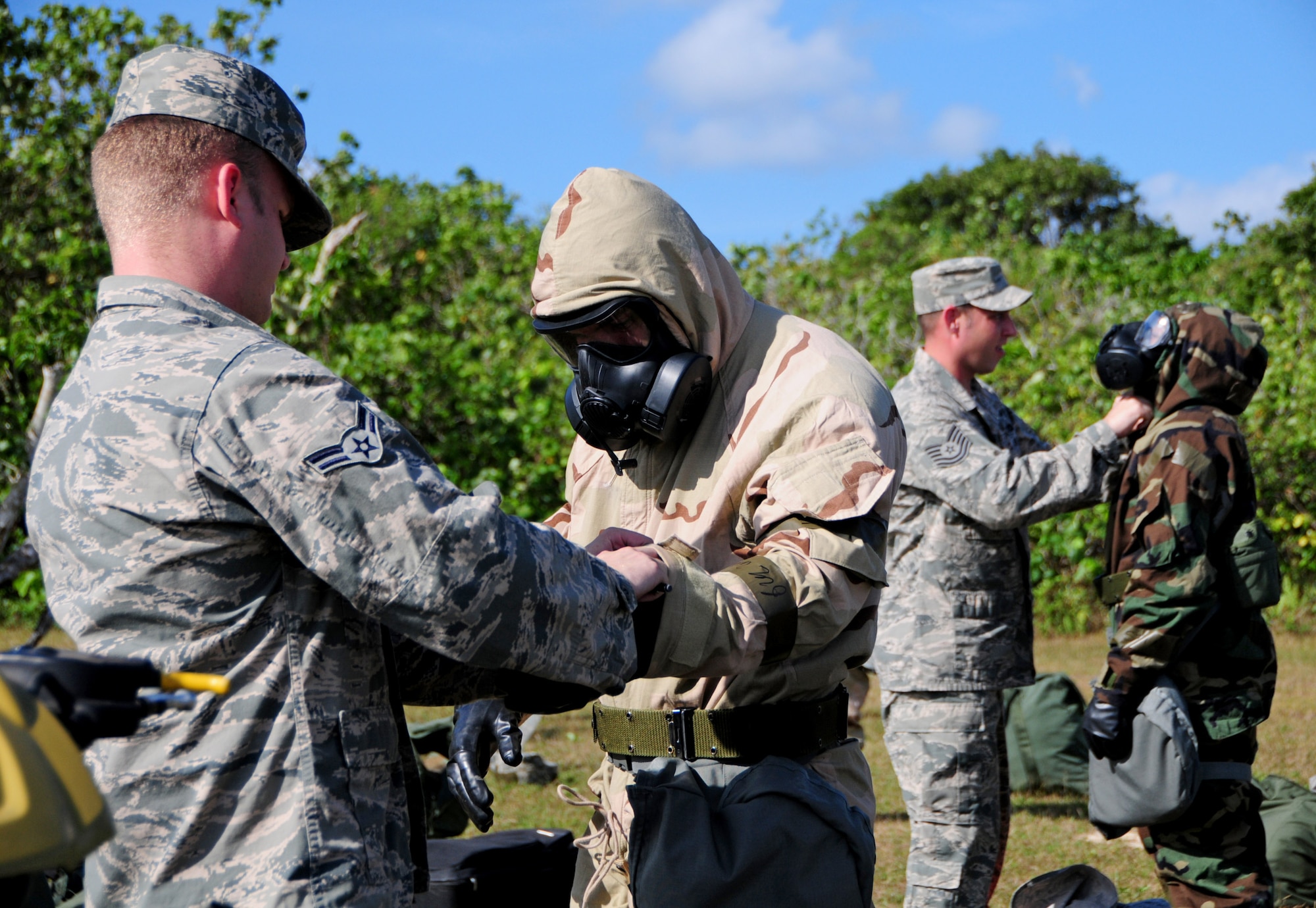 Instructors from the 36th Civil Engineer Squadron readiness and emergency management flight demonstrate how to properly wear their chemical gear during chemical warfare, post-attack reconnaissance training at Andersen Air Force Base, Guam, Jan. 28, 2013. The 36th CES readiness and emergency management flight’s primary mission is to manage programs that save lives, minimize the loss or degradation of resources and to sustain and restore operational capability through hazardous physical and environmental threats. (U.S. Air Force photo/Airman 1st Class Marianique Santos/Released)