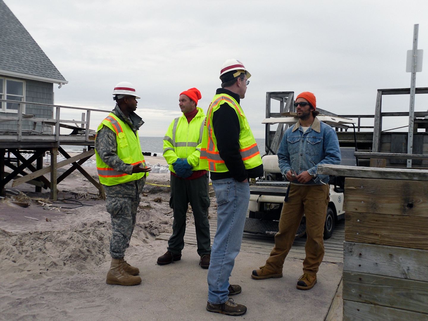 New York Recovery Field Office Commander Lt. Col. John A. Knight (at left) and RFO Operations Chief Sean O'Donnell speak with local homeowners, Fire Island, N.Y., Jan. 11, 2013. The Corps of Engineers and the municipalities on Fire Island are exploring alternate ways of removing debris from the narrow walkways and paths that exist on the remote barrier. 