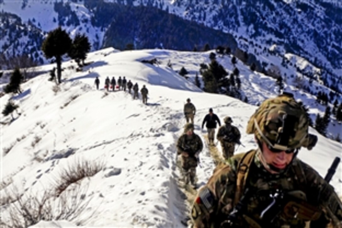 U.S. soldiers and Afghan border police hike from their landing zone to Observation Point 12 along the Afghanistan-Pakistan border, Jan. 21, 2013. The soldiers are assigned to the 101st Airborne Division's 1st Brigade Combat Team.