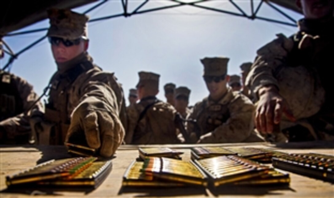 U.S. Marines receive their ammunition at a live-fire range on Camp Leatherneck in  Afghanistan's Helmand province, Jan. 22, 2013.The Marines are assigned to Romeo Battery, 5th Battalion, 11th Marines, Regimental Combat Team 7.