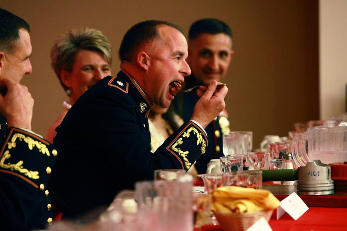 Lt. Col. Daniel J. Bradley, the commander of Combat Logistics Battalion 24, 2nd Marine Logistics Group, bites into a piece of beef covered in hot sauce during the unit’s mess night aboard Camp Lejeune, N.C., Jan. 25, 2013. Bradley fought through the burning sensation of a sauce fittingly named “The Reaper” before declaring the meat ready for the guests in attendance. 