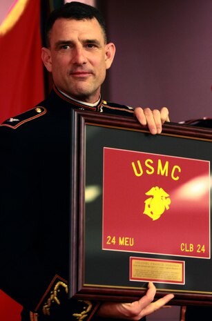 Col. Frank L. Donovan, the commanding officer of the 24th Marine Expeditionary Unit, holds a plaque presented to him by the Marines and sailors with Combat Logistics Battalion 24, 2nd Marine Logistics Group during the battalion’s mess night aboard Camp Lejeune, N.C., Jan. 25, 2013. Donovan congratulated the servicemembers on their performance while serving with the 24th MEU and thanked them for the unique logistical support the battalion provided during the unit’s recent deployment. 