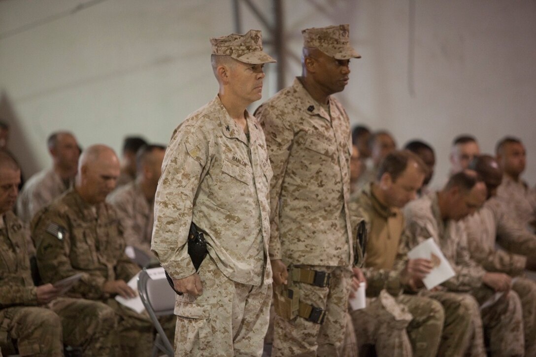 Colonel James Hanlon, left, commanding officer, I Marine Expeditionary Force Headquarters Group (Forward), and Sgt. Maj. Kenneth Rocquemore, sergeant major, I MHG (Fwd), prepare to ceremoniously hand responsibility to II MHG (Fwd), during a transfer of authority aboard Camp Leatherneck, Afghanistan, Jan. 24, 2013. The unit worked with coalition forces from the United Kingdom, Denmark and Tonga during their yearlong deployment.