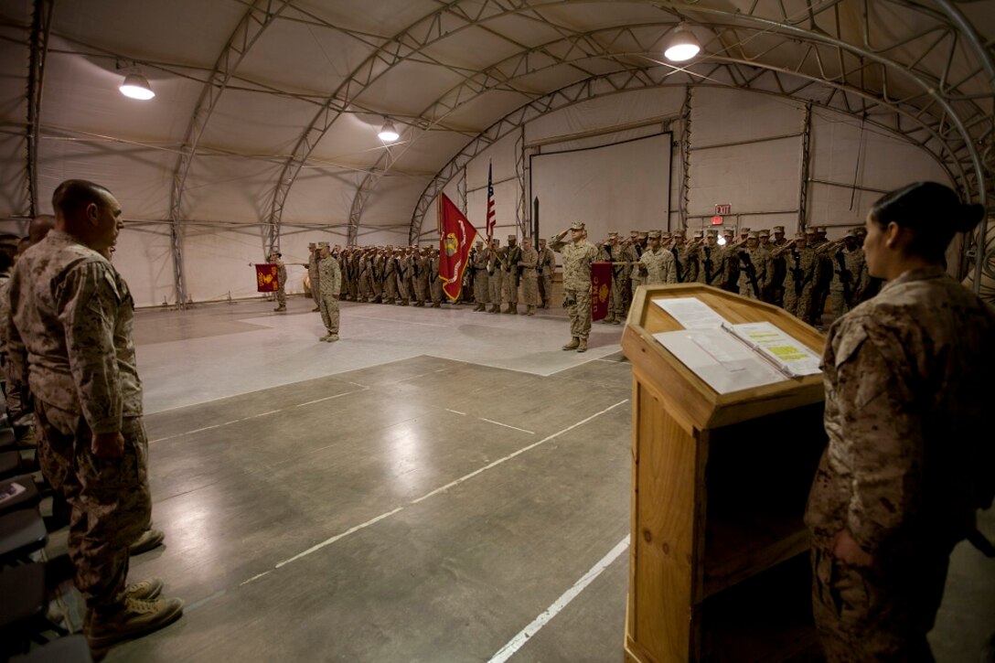 Marines and sailors with I Marine Expeditionary Force Headquarters Group, and Marines and sailors with II MHG (Fwd), render a salute during a transfer of authority ceremony aboard Camp Leatherneck, Afghanistan, Jan. 24, 2013. Servicemembers with II MHG (Fwd) takes over an area that saw several changes in the past year, from Afghan National Security Forces led operations to the retrograde process of gear.