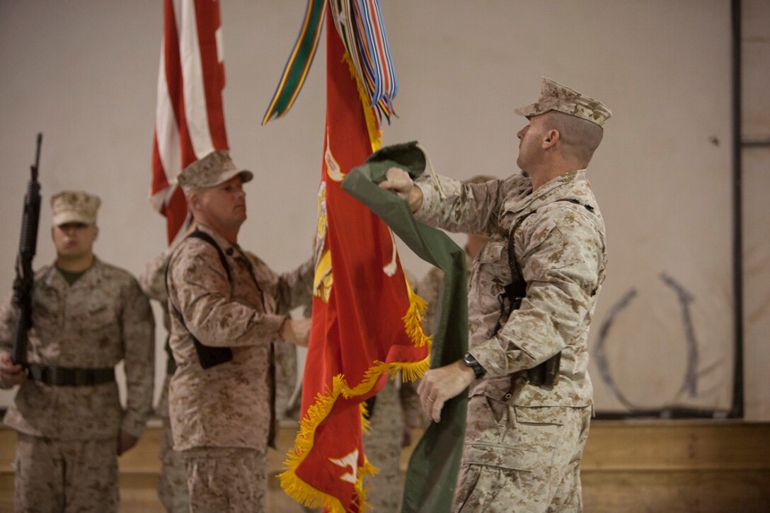 Colonel James Stopa, right, commanding officer, II Marine Expeditionary Force Headquarters Group (Forward), and Sgt. Maj. Joseph Shaw, sergeant major, II MHG (Fwd), uncase the unit's Battle Colors during a transfer of authority ceremony aboard Camp Leatherneck, Afghanistan, Jan 24, 2013. The unit takes over for I MHG (Fwd) in Helmand province, Afghanistan.