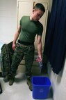 A sailor with 2nd Marine Logistics Group drops an empty water bottle into a recycling bin in a barracks room aboard Camp Lejeune, N.C., Jan. 22, 2013. Servicemembers with the unit received containers for recycling to help reduce waste sent to the base’s landfill in an ongoing effort to improve recycling efforts. 