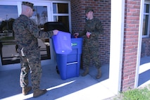 Servicemembers with 2nd Marine Logistics Group empty a recycling bin taken from their barracks room into a collection container aboard Camp Lejeune, N.C., Jan. 22, 2013. Marines and sailors received individual recycling bins to reduce the amount of improperly disposed of materials in their rooms.