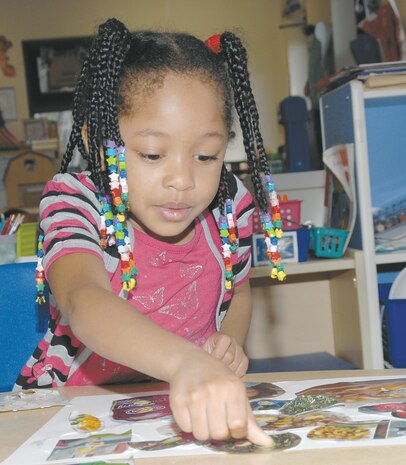 Children at Marine Corps Logistics Base Albany’s Child Development Center sharpen their motor skills during arts and crafts time Monday by creating collages using glue, paper squares and magazine cutouts.