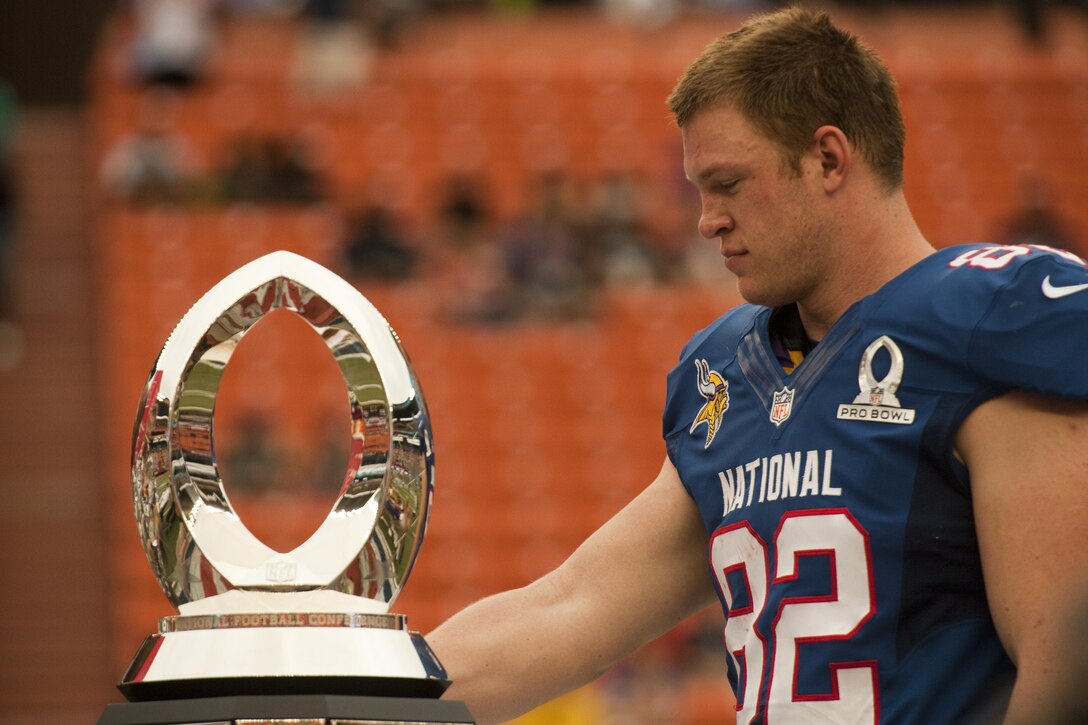 Minnesota Vikings tight end Kyle Rudolph eyes his 2013 Pro Bowl Most Valuable Player award that he received for his performance at Aloha Stadium, Jan. 27. The Marines at the Pro Bowl contributed to the festivities with a color guard, stage assistance, a troop formation and a welcoming home for Marines recently returned from deployment at halftime.