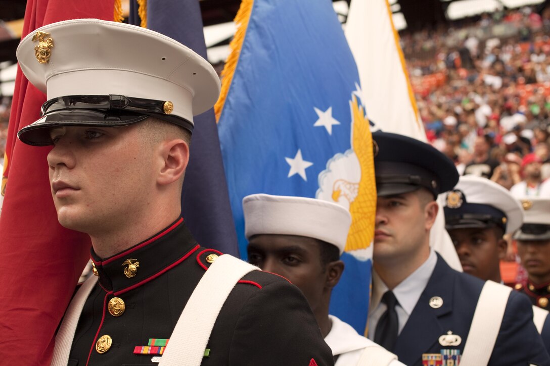 Cpl. Joseph Stewart (left), the property clerk with Headquarters and Service Battalion, U.S. Marine Corps Forces, Pacific, and his fellow servicemembers prepare to march the colors onto the field for the national anthem during the 2013 NFL Pro Bowl at Aloha Stadium, Jan. 27. The Marines at the Pro Bowl contributed to the festivities with a color guard, stage assistance, a troop formation and a welcoming home for Marines recently returned from deployment at halftime. 